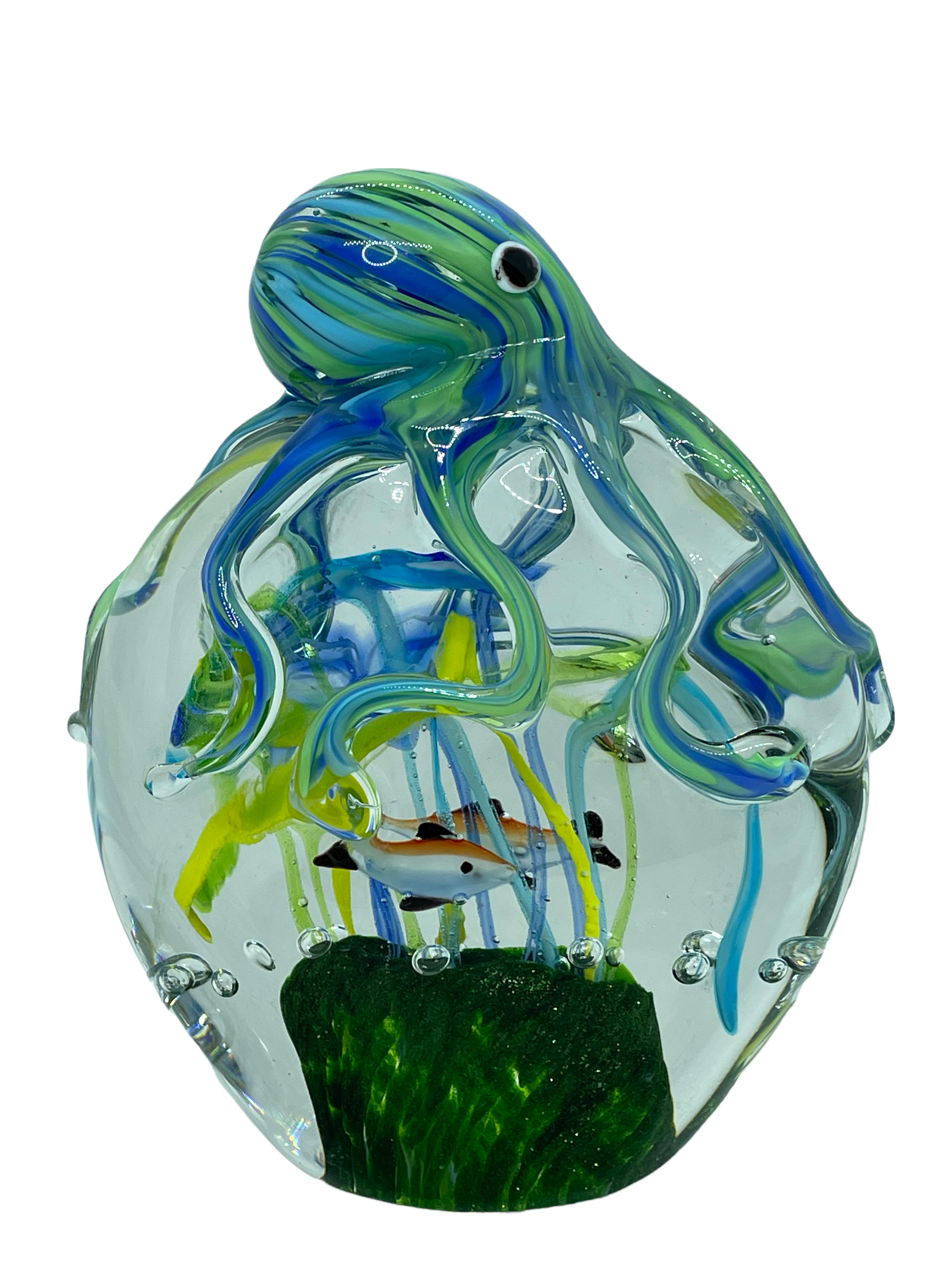 Beautiful Murano hand blown aquarium Italian art glass paper weight. Showing a octopus holding a reef with fish aquarium. Colors are a different shades of blue, white, black and clear. A beautiful nice addition to your desktop or as a decorative