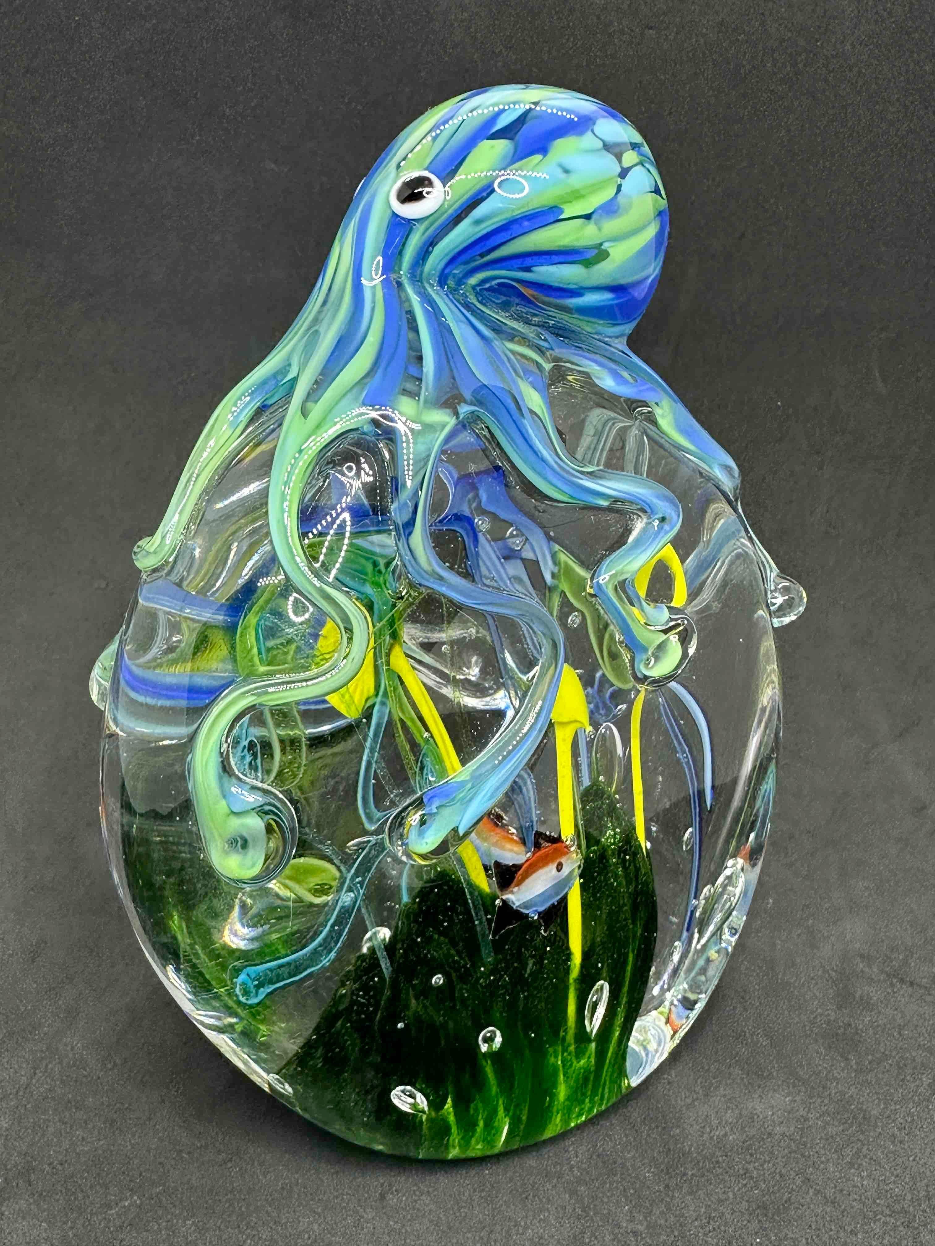 Beautiful Murano hand blown aquarium Italian art glass paper weight. Showing a octopus holding a reef with fish aquarium. Colors are a different shades of blue, white, black and clear. A beautiful nice addition to your desktop or as a decorative