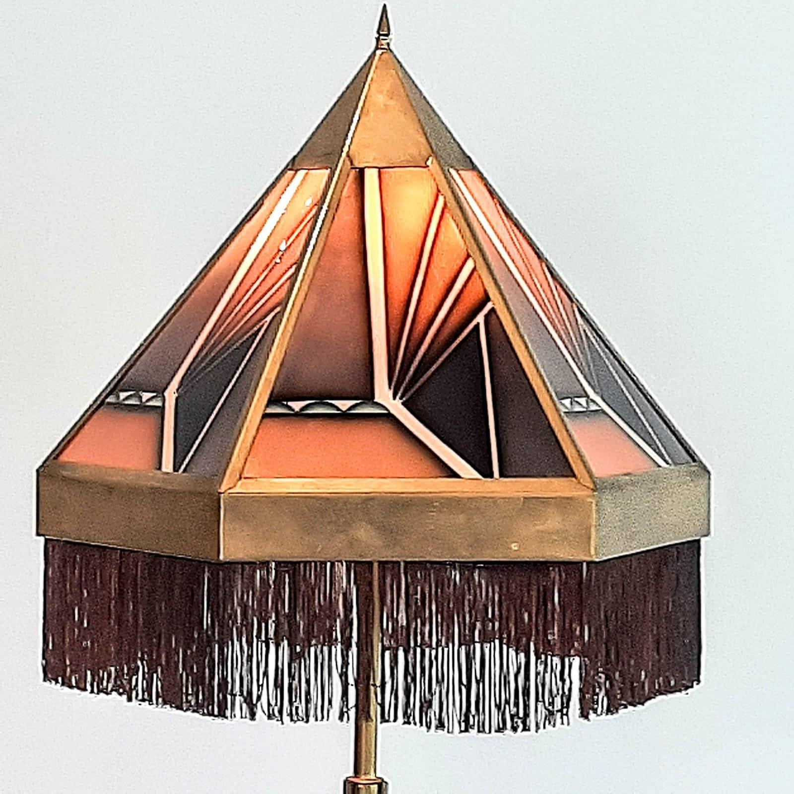 This beautiful Art Deco floor lamp has insane colors with a beautiful brass frame.Art Deco lamp originates from the Amsterdamse School and was manufactured in the 1920s in the Netherlands.

Unique item, hard to find.

The hexagon-shaped shade with