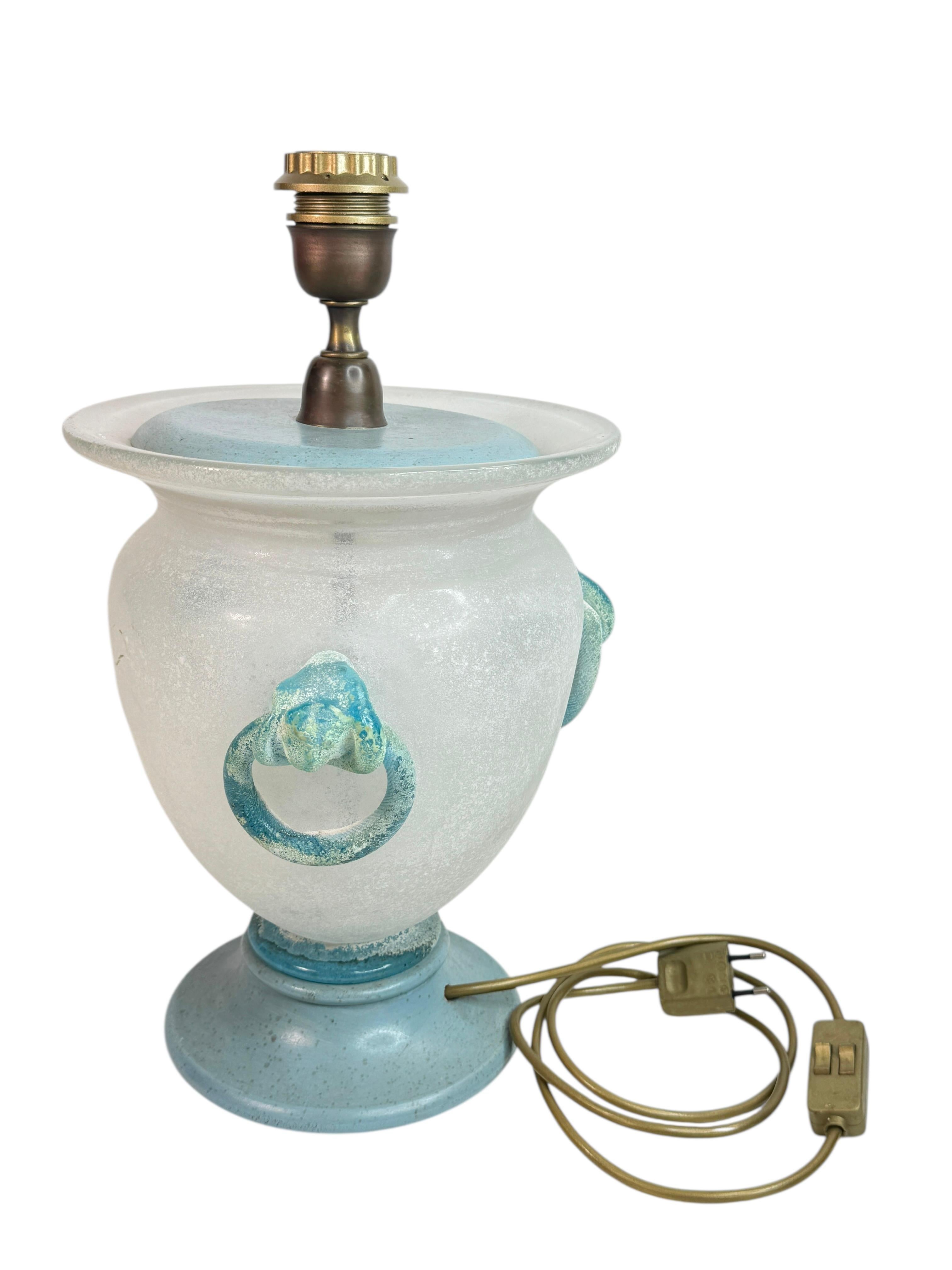 A round glass vase mounted as circular table lamp, in aquamarine or turquoise, crafted using the Scavo technique. Made in Murano near Venice, Italy, circa 1980.

The mouth-blown glass in a beautiful weiss beigen tone with Florentine details