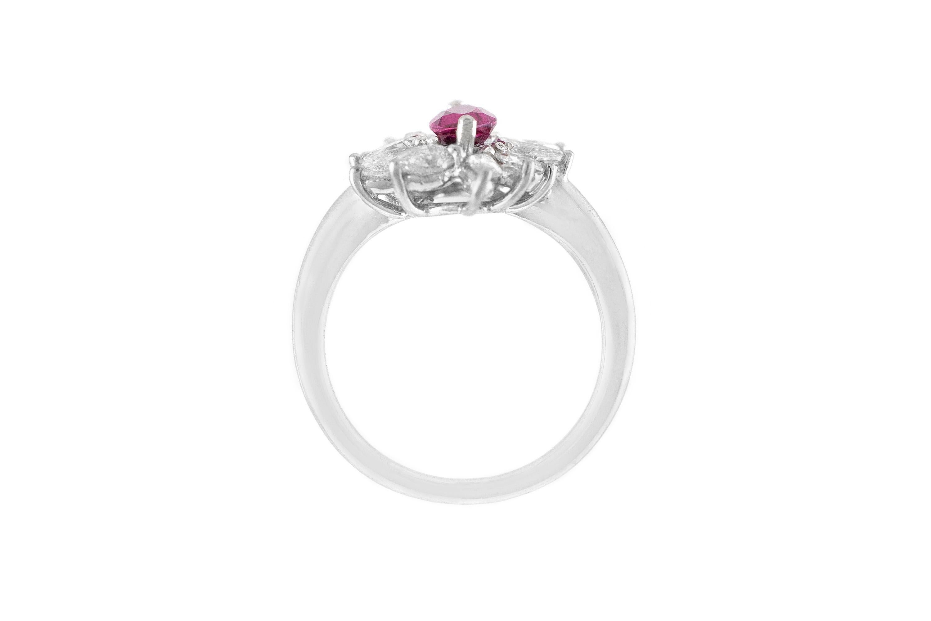 The ring is finely crafted in 18k white gold with center stone pink sapphire weighing approximately total of 1.32 carat and pear and marquise diamonds weighing approximately total of 1.15 carat.