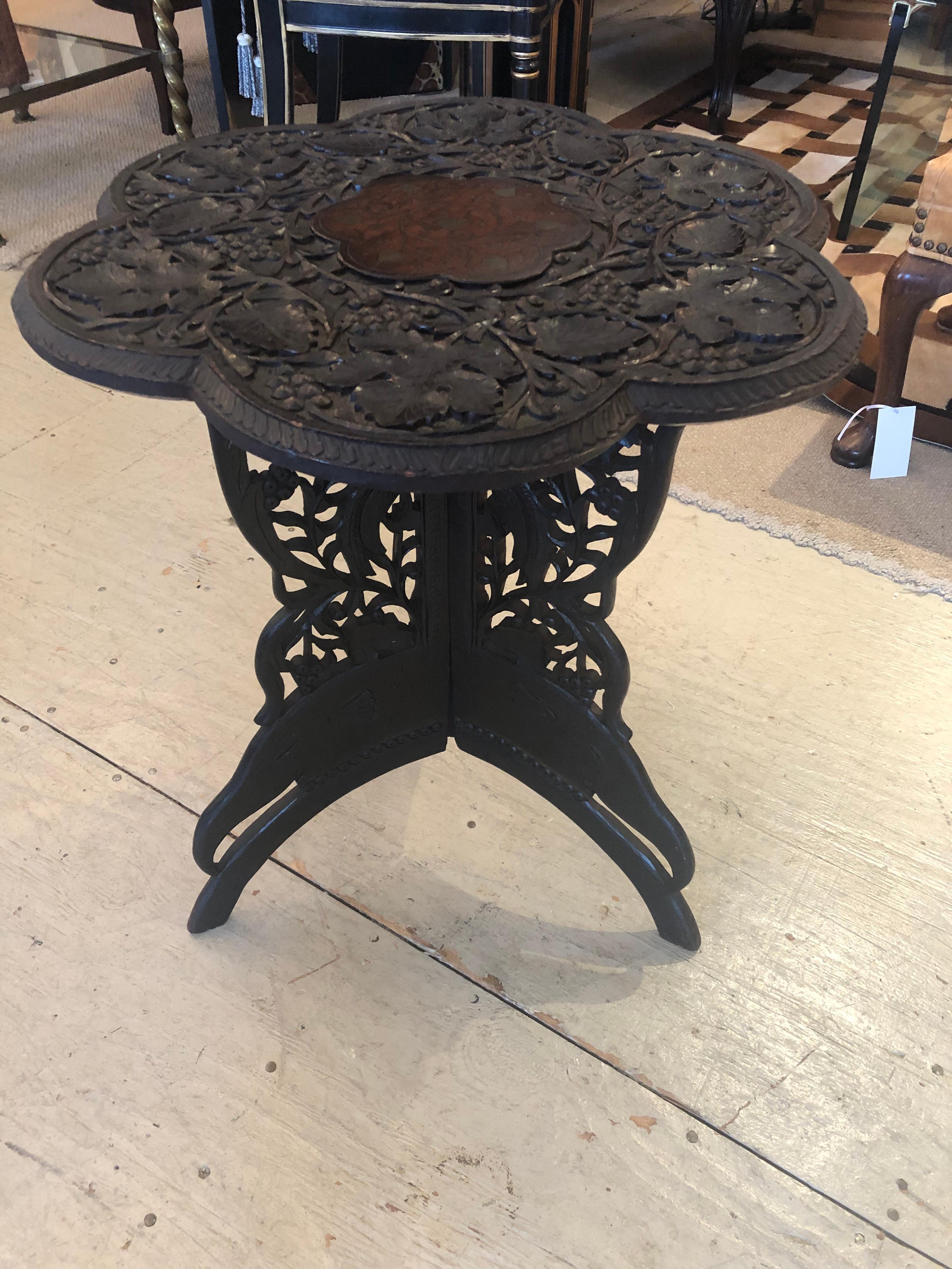 A lovely carved wood and inlaid Anglo-Indian or Moroccan style drinks table having a scalloped flower shaped top and intricately carved 4 part butterfly base.