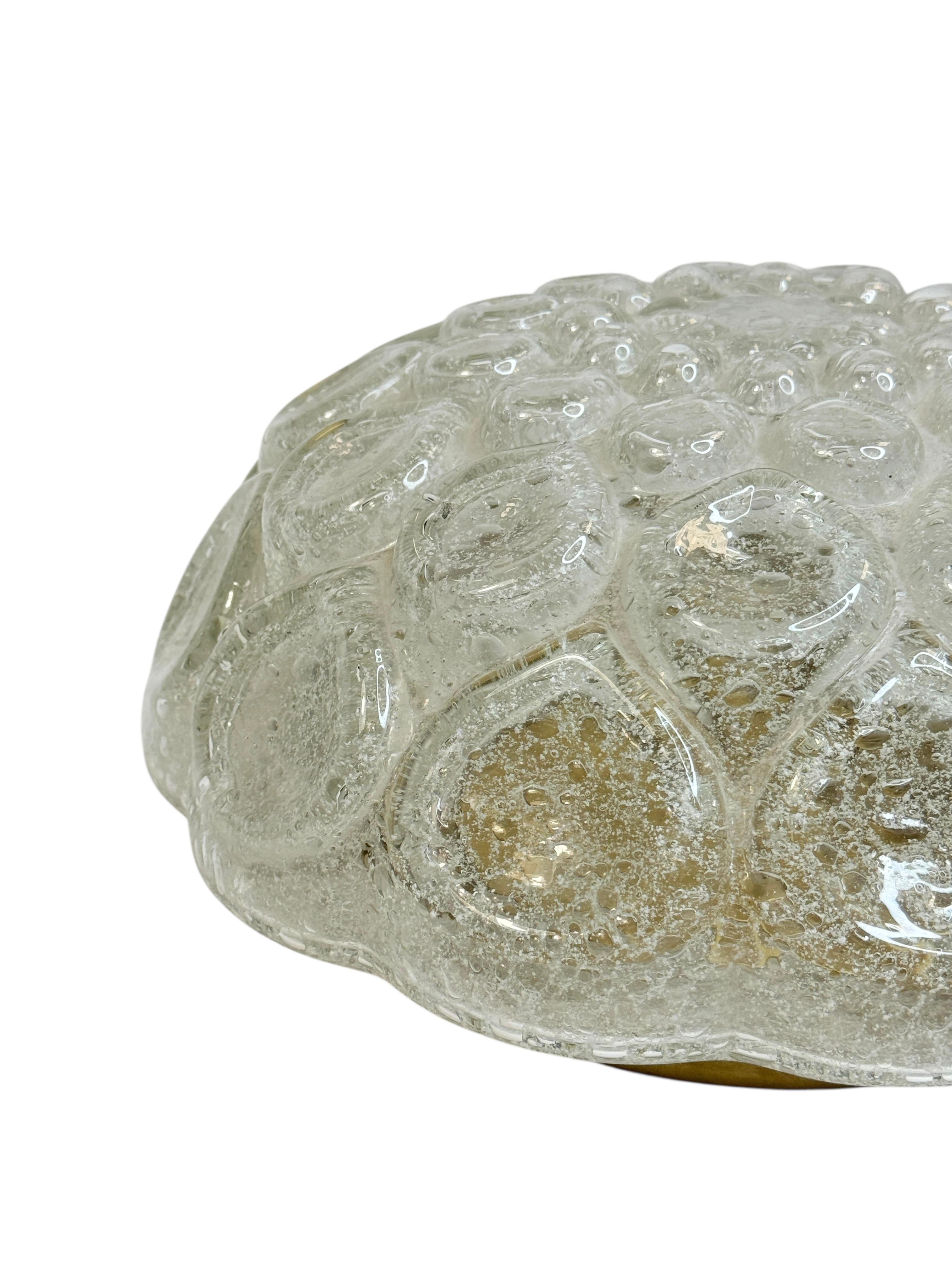 Doria Leuchten Glass Bubble Flush Mount Ceiling Light, Germany, 1970s

A gorgeous glass bubble-pattern flush mount ceiling light by Doria Leuchten, crafted in Germany in the 1970s. The design features a thick, hand-molded glass shade with a