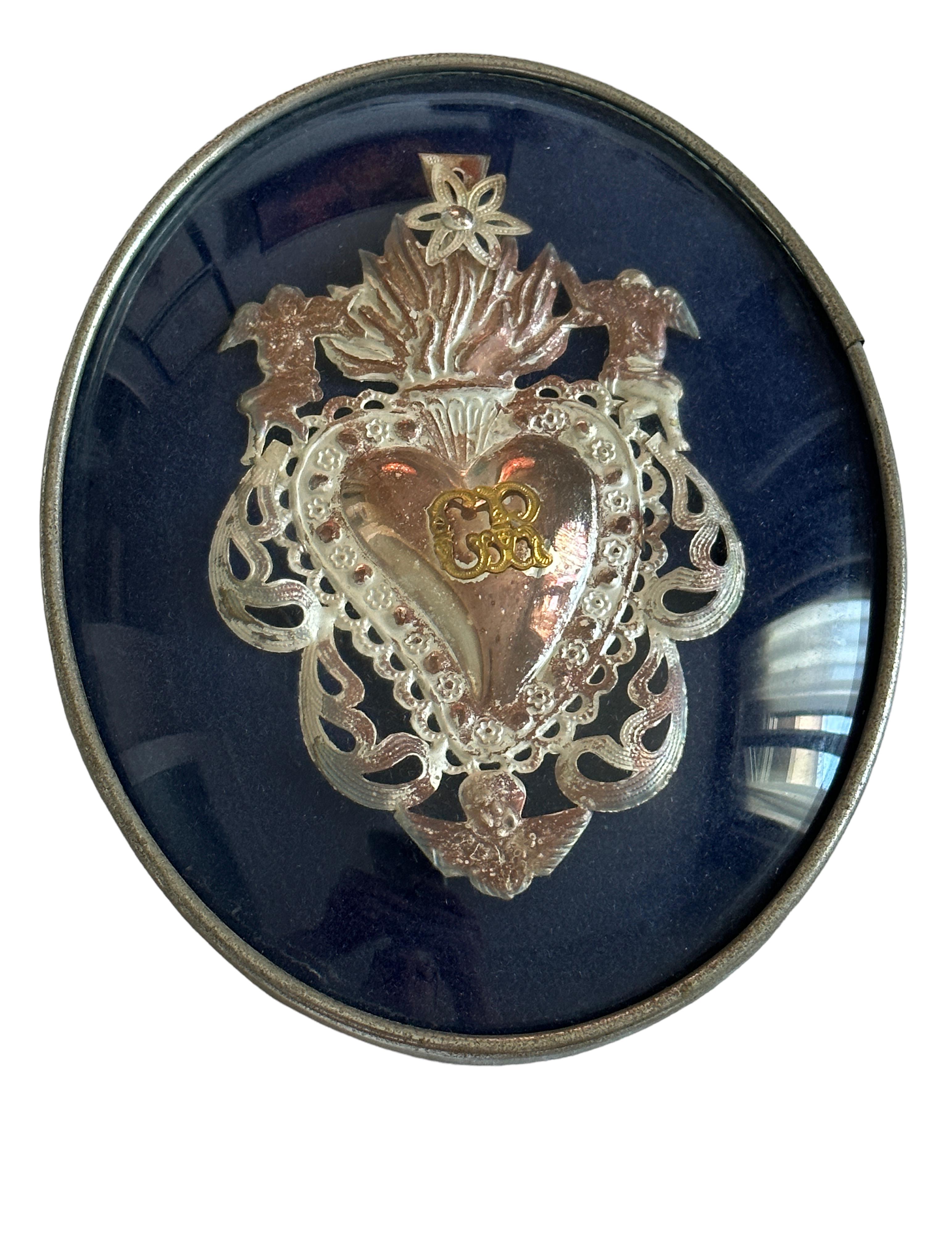 Framed and donated in the 1970s this antique ex voto is a real beautiful collectible. I do not know what it is made of, thin and light filigree silver or silver plated metal. It is handmade, embossed and then welded. Given the delicacy, I did not