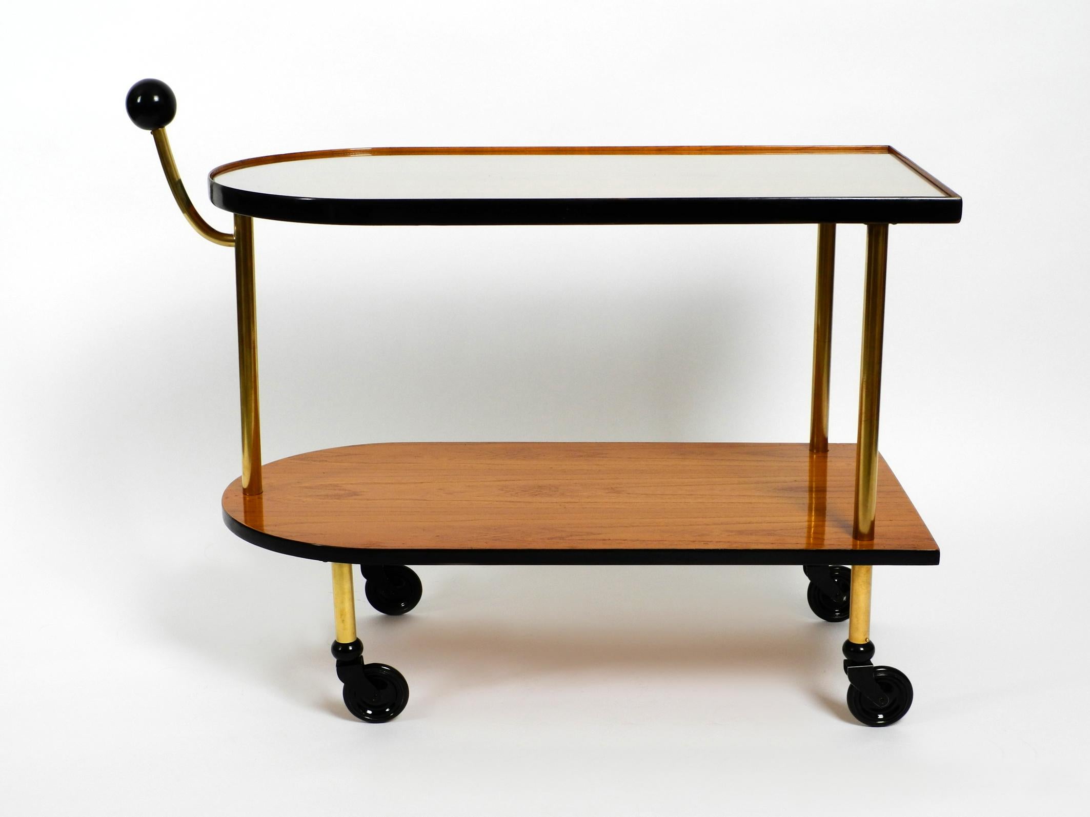 Very rare and beautiful French 1930s Art Deco serving trolley. 
With a glass plate on the upper shelf. Completely refurbished. 
The wooden panels are veneered with ash.
The surfaces were polished with ruby shellac, the top edges with black piano