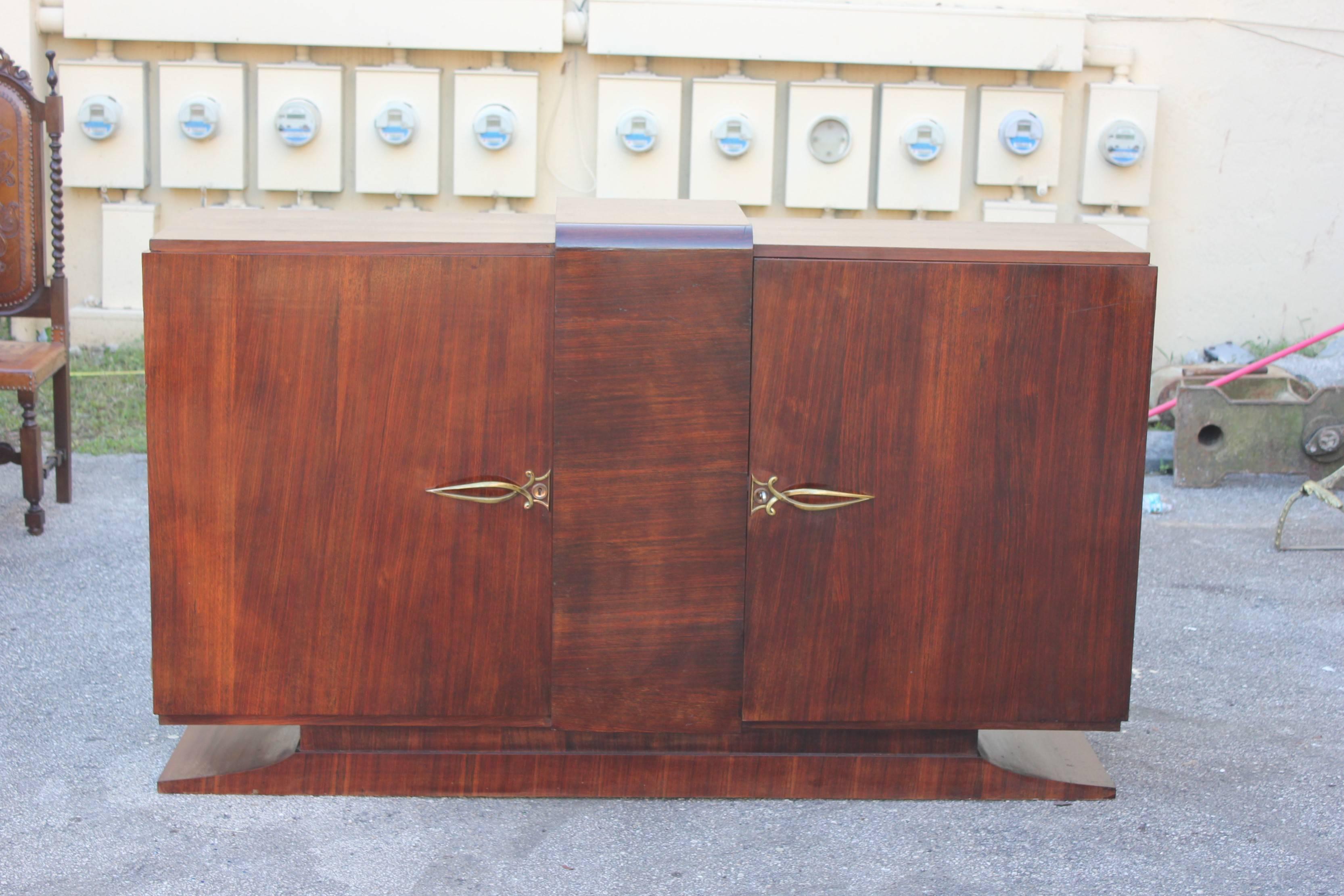 Beautiful French Art Deco Macassar ebony sideboard, buffet or bar, circa 1940s. The sideboard are two doors and center design with mustache legs very Classic Art Deco, the sideboard are in very good condition with the original finish. Size: 70.50 W,