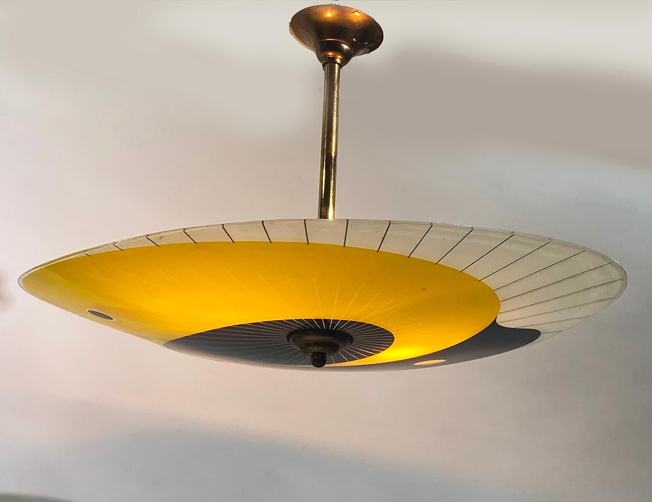 French Art Deco pendant chandelier, circa 1930s. 
Colorful lampshade hung on its brass fixture. 
Measures: Height : 40 cm, Diameter : 57 cm. 
Delivered wired for your country (US, EU, China, Australia, etc...).