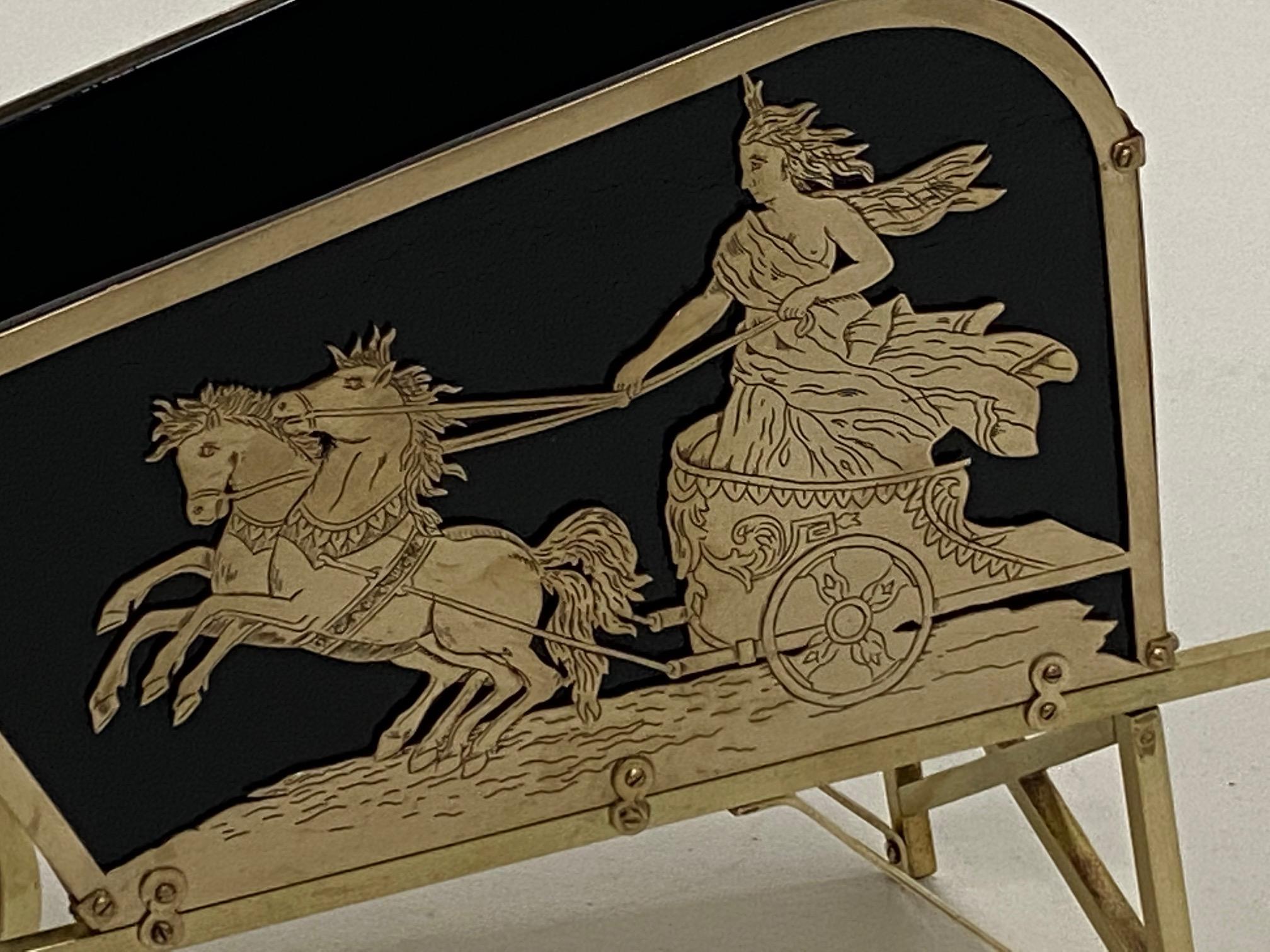 Gorgeous brass wheelbarrow shaped centerpiece having neoclassical decoration of chariot scenes and original ebonized wood liner.