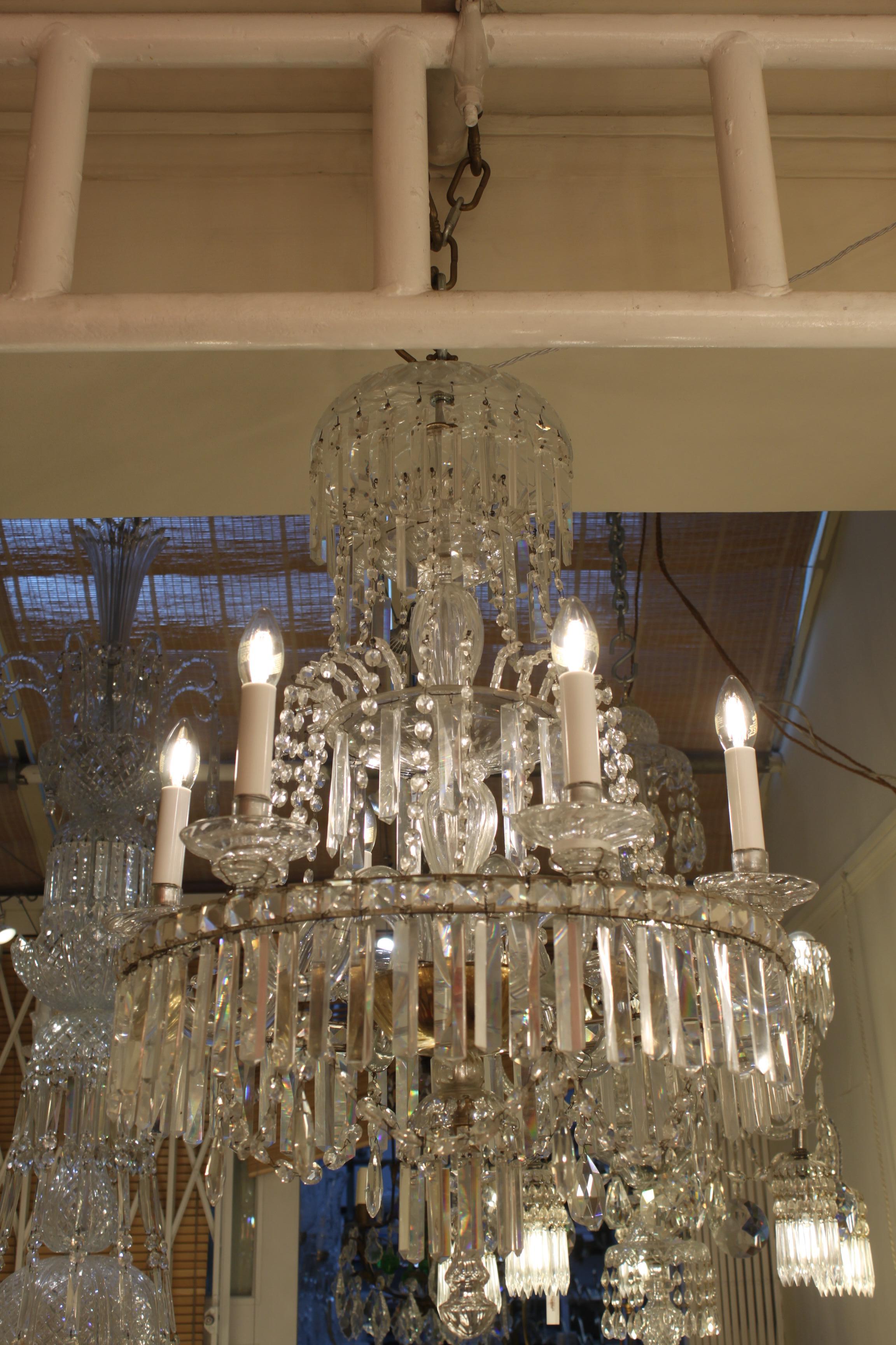 This single round shaped crystal chandelier with six glass arms and lights is in perfect condition . Its very well balanced proportions give a very attractive aspect . All the crystal pieces are in very good shape.

The lower larger ring from