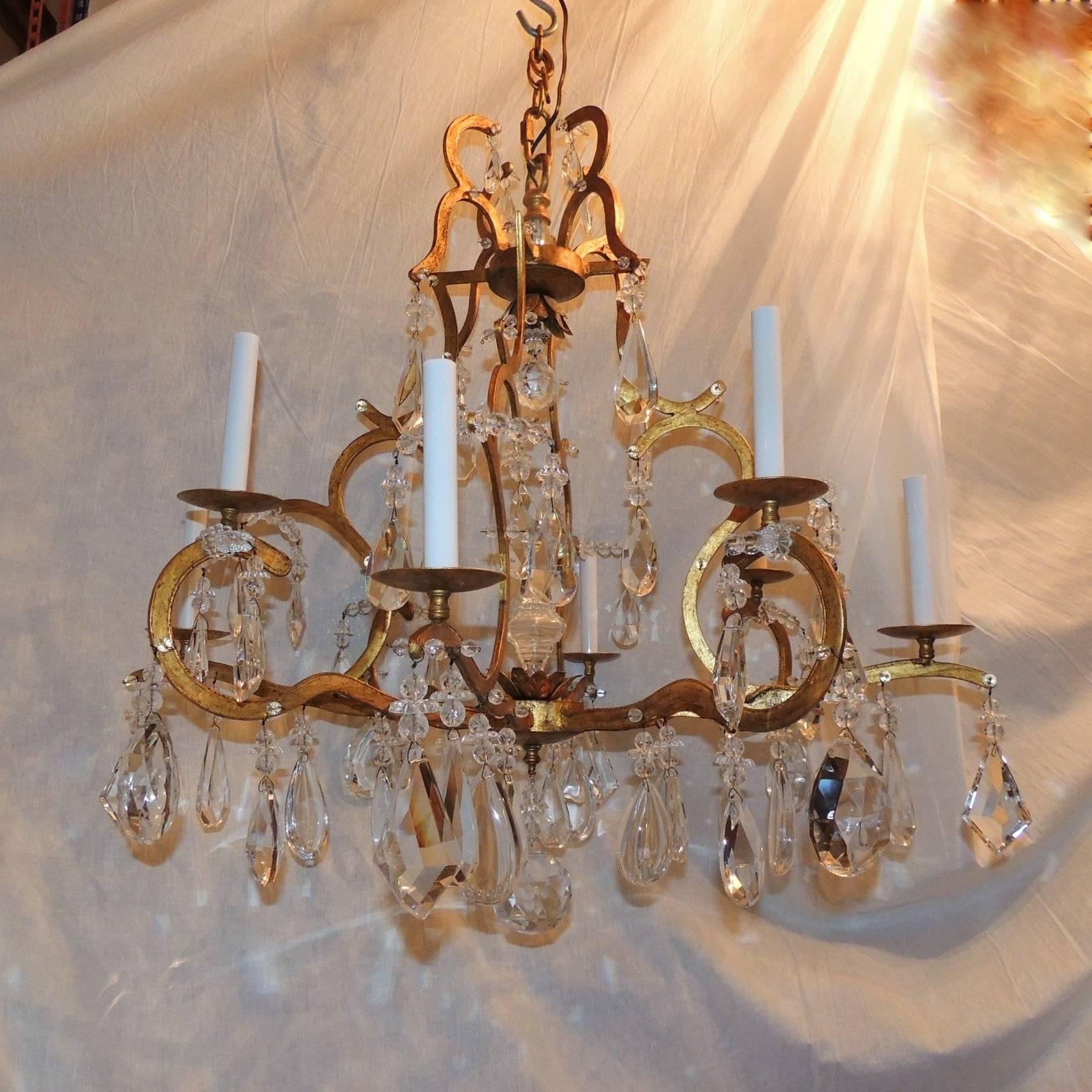 Wonderful large eight-arm gilt bird cage form chandelier with multi shape faceted crystals throughout in the manner of Jansen & Baguès.


Measures: 33