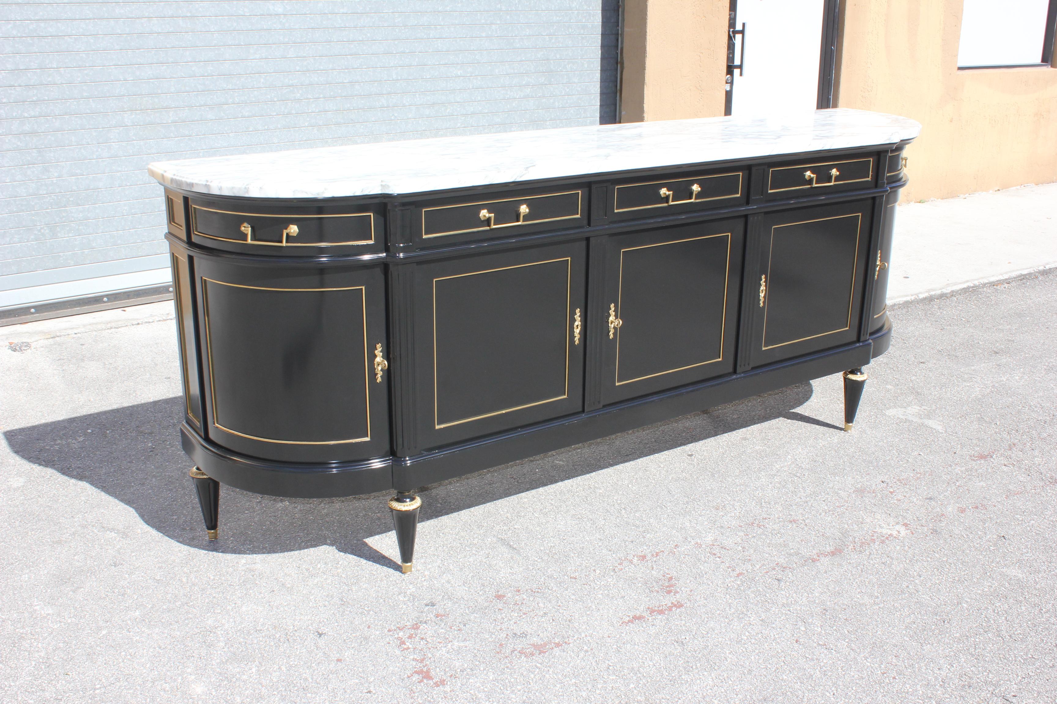 Long French antique Louis XVI style sideboard or buffet made of mahogany with a beautiful Carrara marble top, the mahogany wood has been ebonized and finished with a French polished high luster. The buffet has 5 doors and 5 drawers, and bar section,