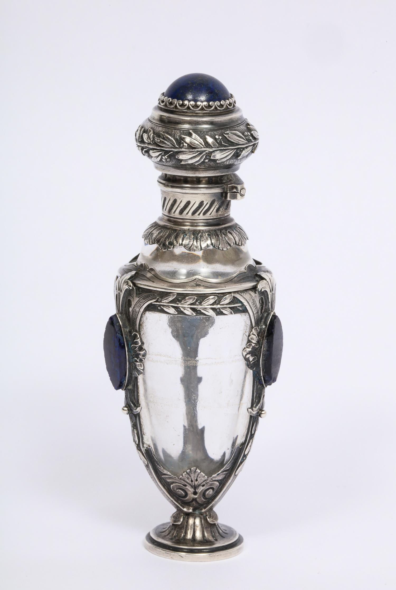 A beautiful French silver, lapis Lazuli, and glass perfume scent bottle,
late 19th century.

Very fine quality silver. Mounted with Lapis Lazuli.

Measures: 4