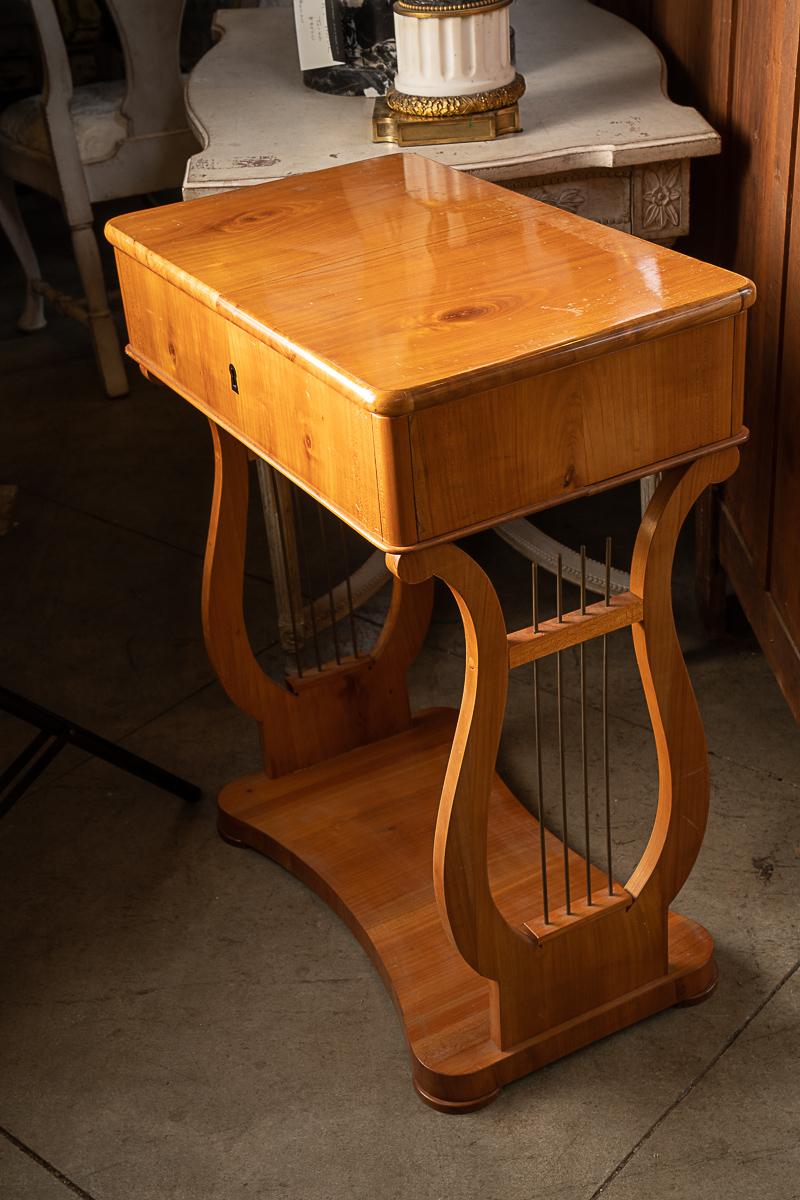 This is a really beautiful piece that is all about the wood and the design. The detail of the lyre legs and the beautiful patina makes it a standout in any place in any room. The wonderfully aged fruitwood has a glow to it that adds to the overall