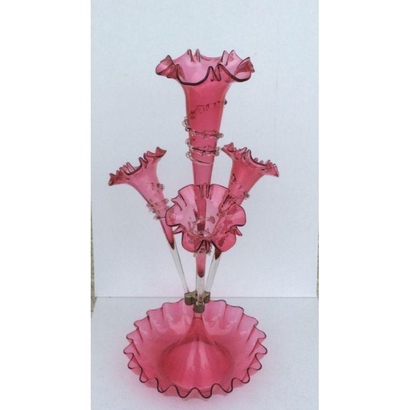Beautiful genuine antique ruby glass Epergne,

Circa 1880
Measures: 21.75ins tall x 10 ins diameter base
(Centre flute locks in outer three flutes)

Declaration: This item is antique. The date of manufacture has been declared as