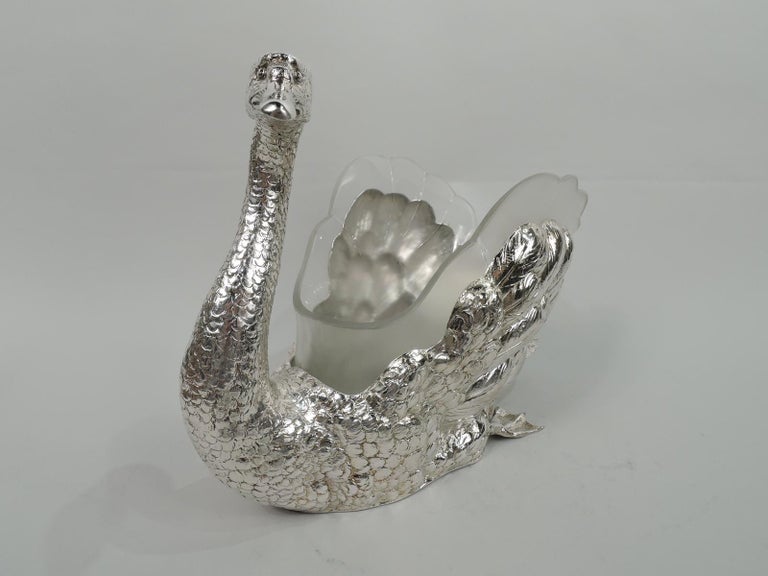 Beautiful German sterling silver swan bowl with rare glass liner. A nice-sized bird with twisting s-scroll neck, closed bill, and direct expression. Gently protuberant haunches and webbed feet in glide mode. Fine delineation of feathers from scaly