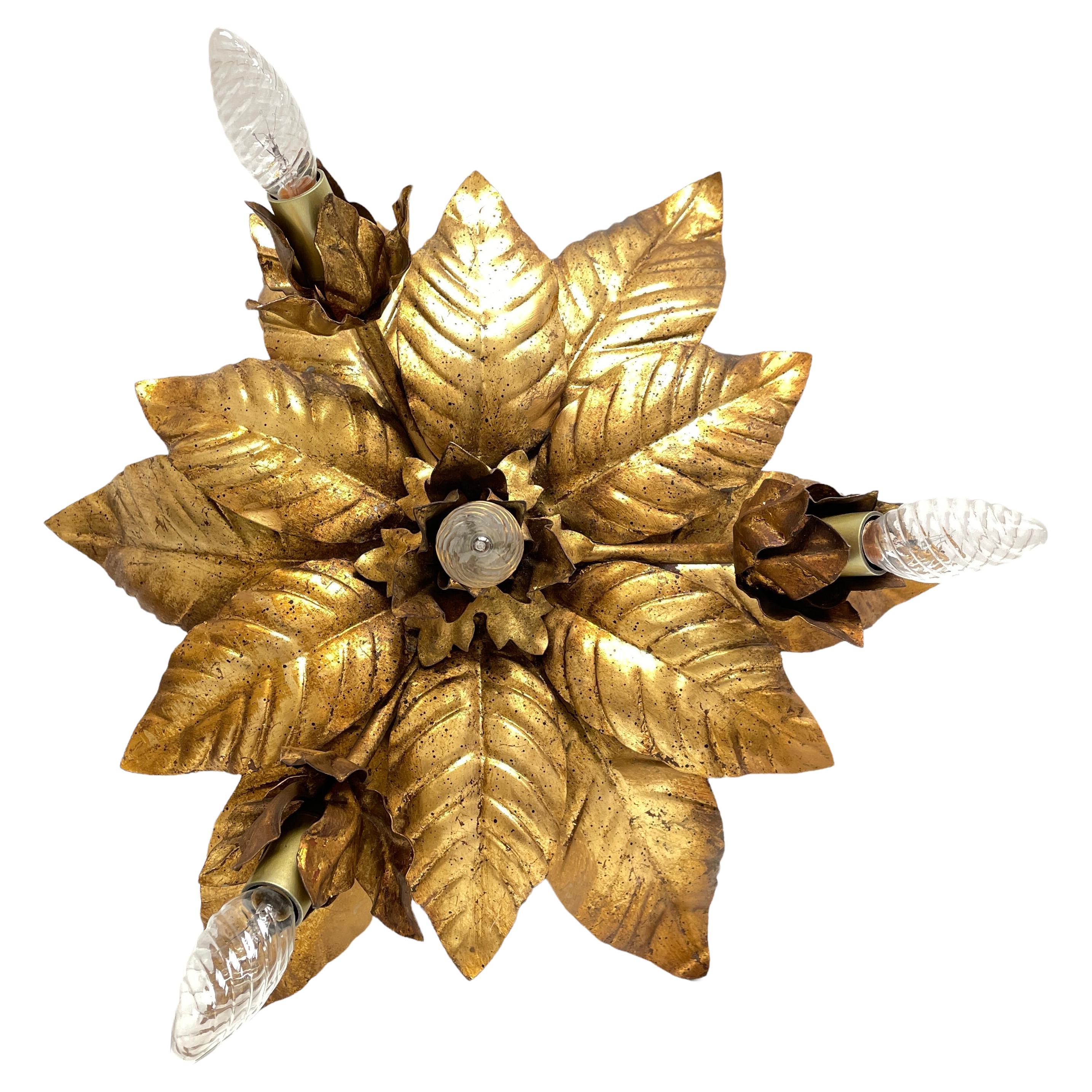 Add a touch of opulence to your home with this charming flush mount. Perfect gilded colored leafs to enhance any chic or eclectic home. We'd love to see it hanging in an entryway as a charming welcome home. Built in the 1970s, made by Hans Koegl