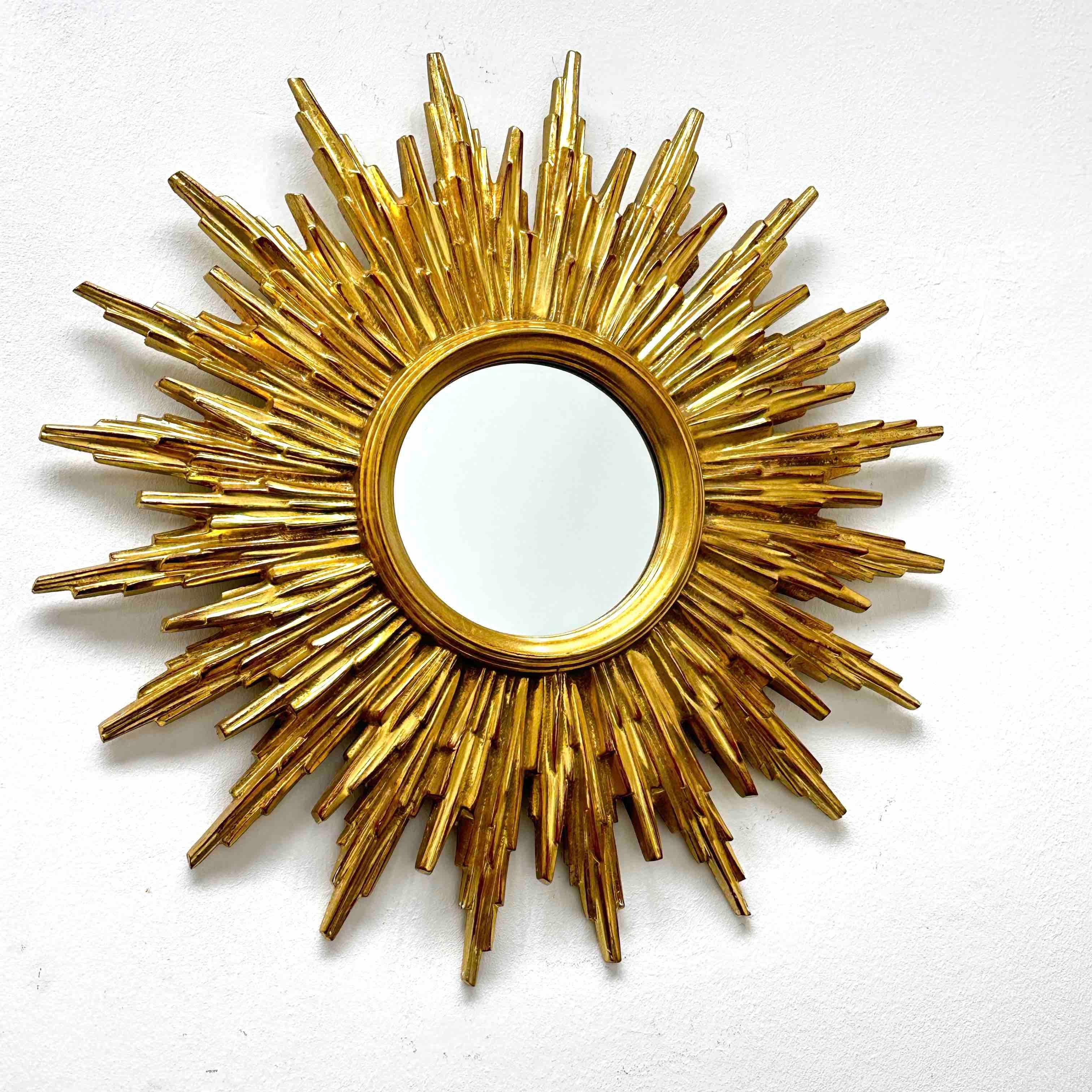 A gorgeous starburst mirror. Made of plastic or resin. No chips, no cracks, no repairs. It measures approximate 19.13