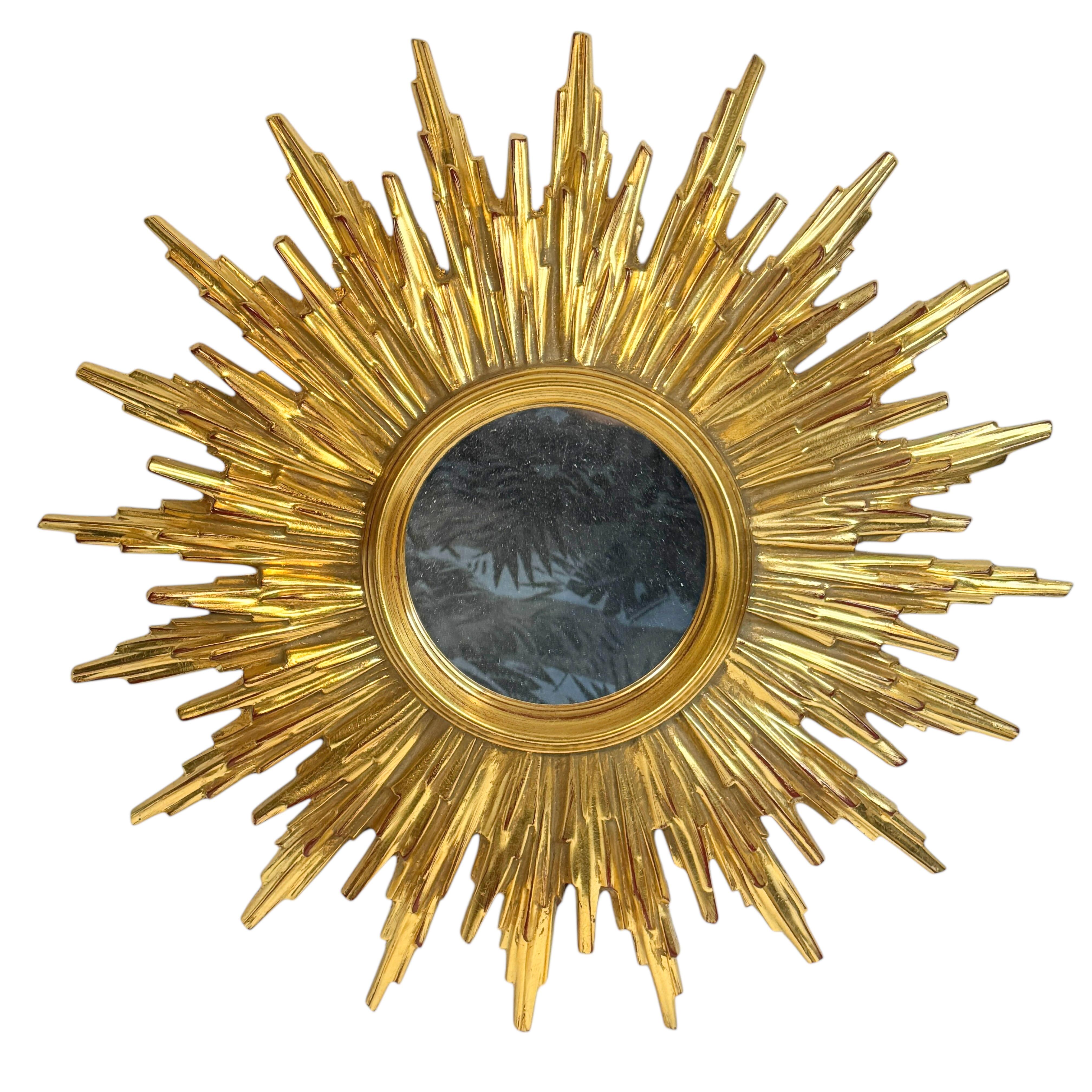 A gorgeous starburst mirror. Made of plastic or resin. No chips, no cracks, no repairs. It measures approximate 19.63