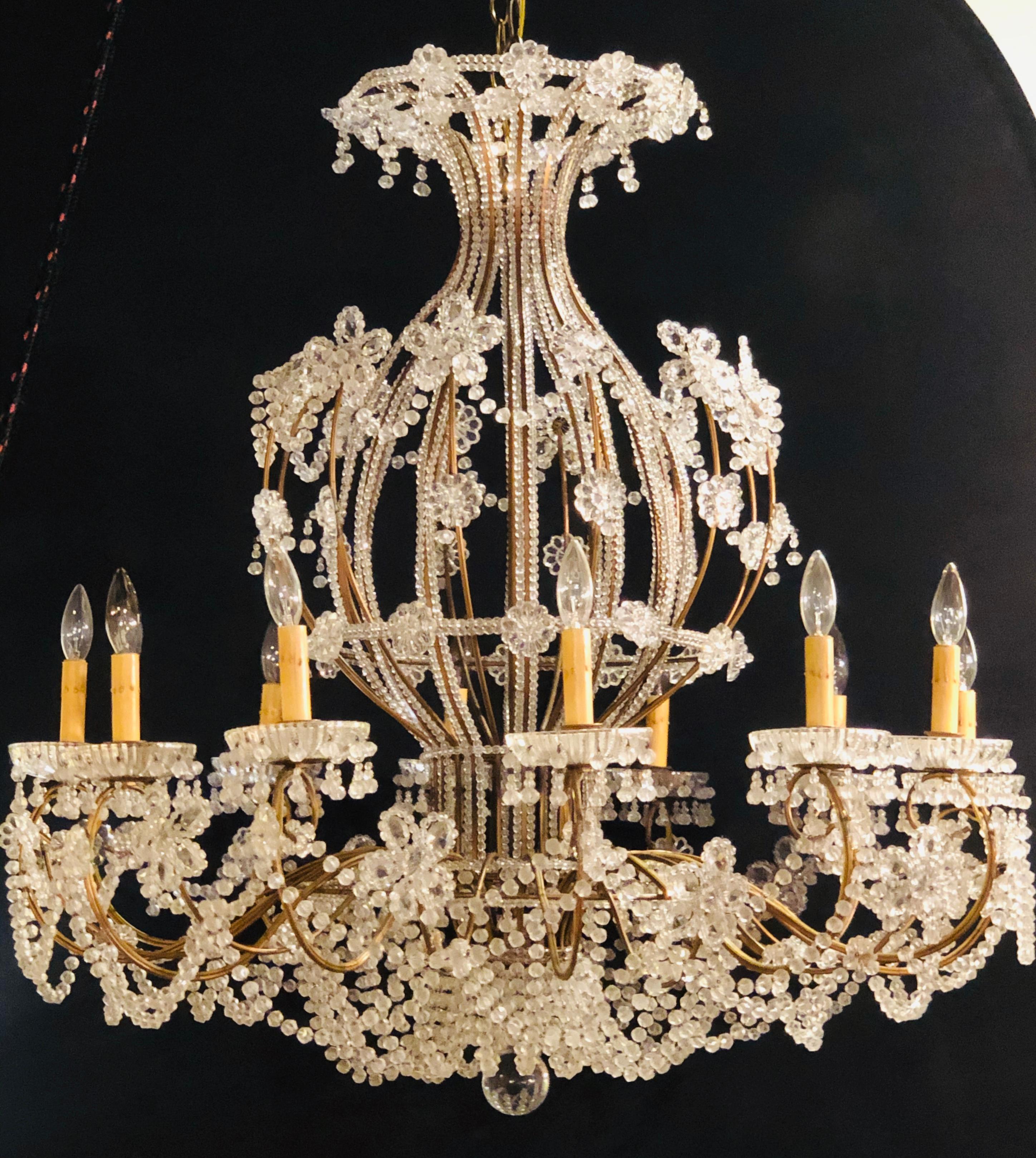 Beautiful gilt iron 12-light chandelier with great crystal and bead decoration. This massive and highly decorative chandelier is simply spectacular having a basket hot balloon form with large oversized bobeches. 

GX.