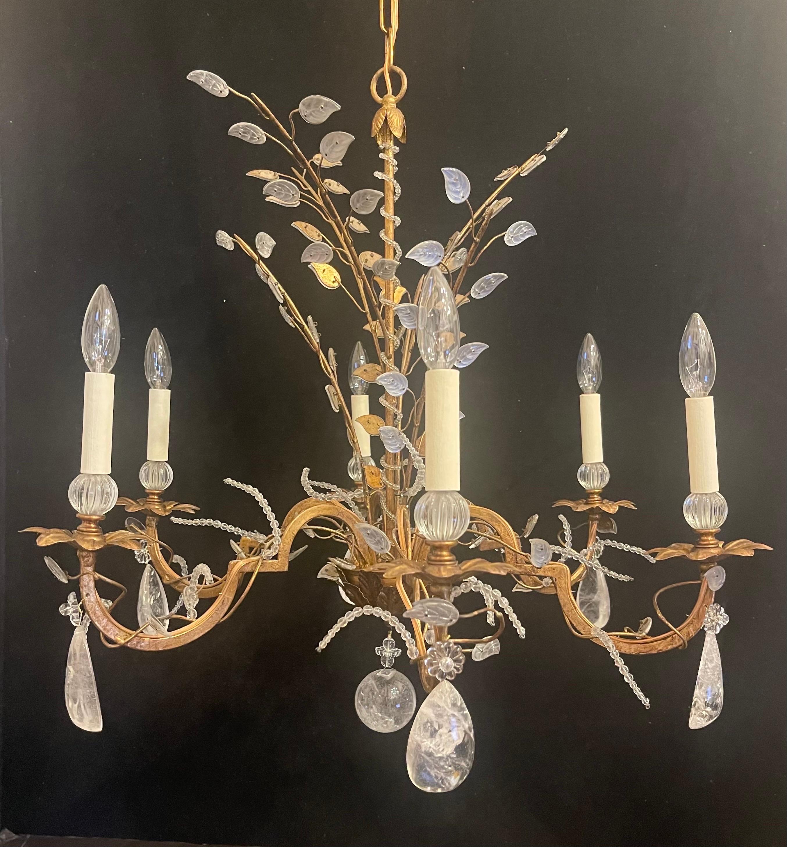 A beautiful gold gilt with rock crystal and crystal leaf basket spray form chandelier by Vaughan designs England, in the manner of Maison Baguès & Jansen with 6 candelabra lights each taking a max of 40 watts per socket.