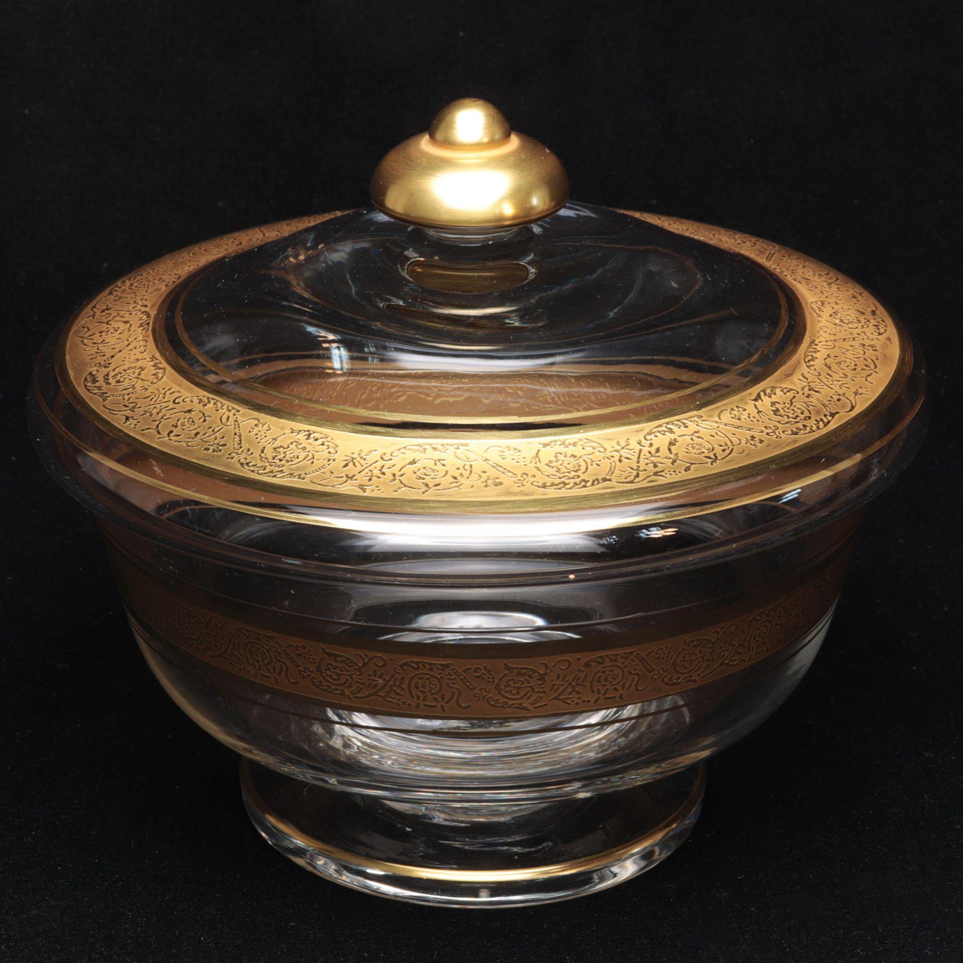 Beautiful hand blown lidded glass bowl, a colorless thick glass, with a lid. stylized floral engraving and relief decoration, 24 karat gold-colored painted. A nice addition to any table.