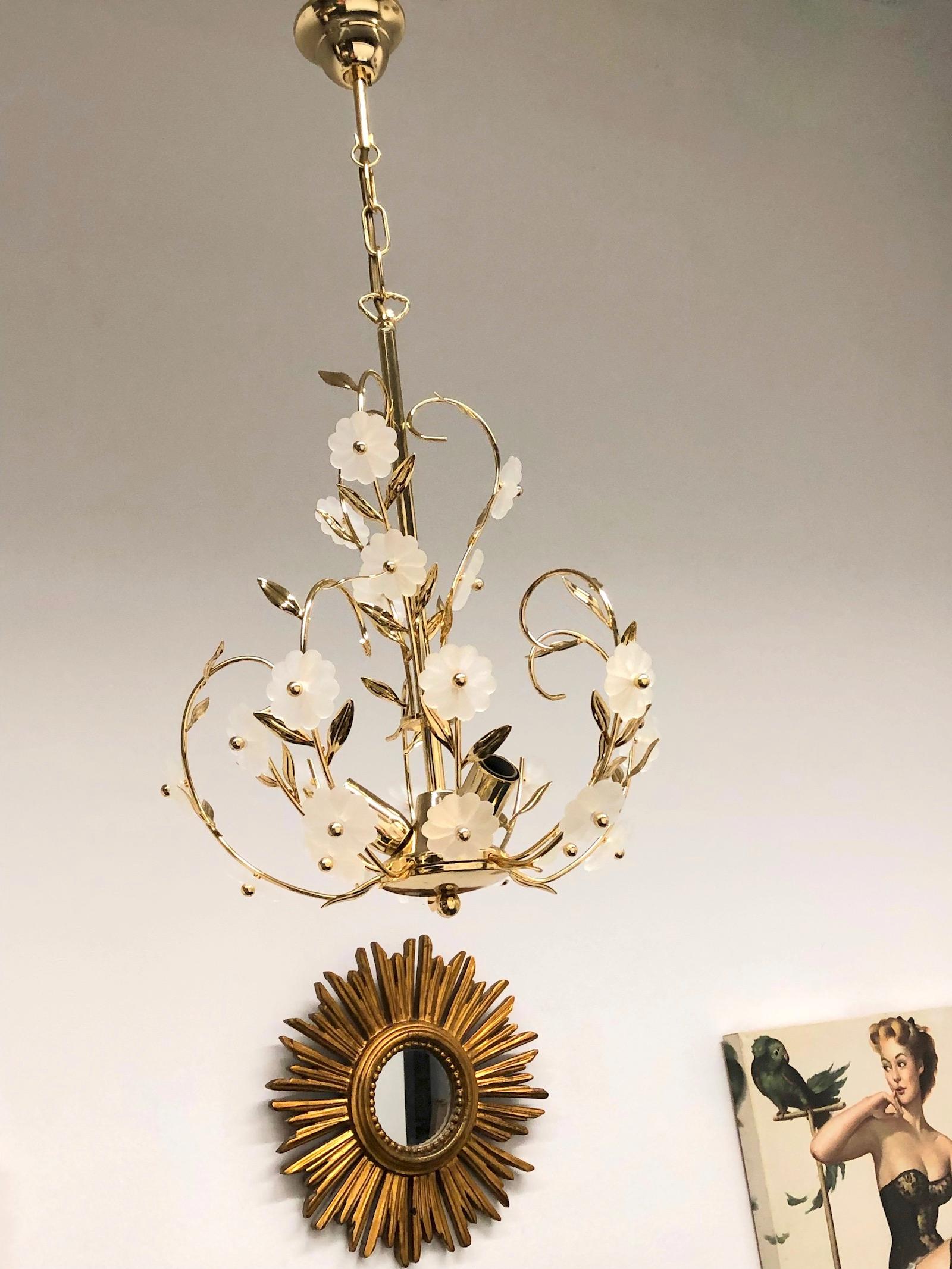 A beautiful brass and glass flower chandelier made by Soelken Leuchten, Germany, 1960s. The chandelier requires three European E14 candelabra bulbs, each up to 40 watts. It is made of Murano glass flowers and a brass frame.
This beauty will look