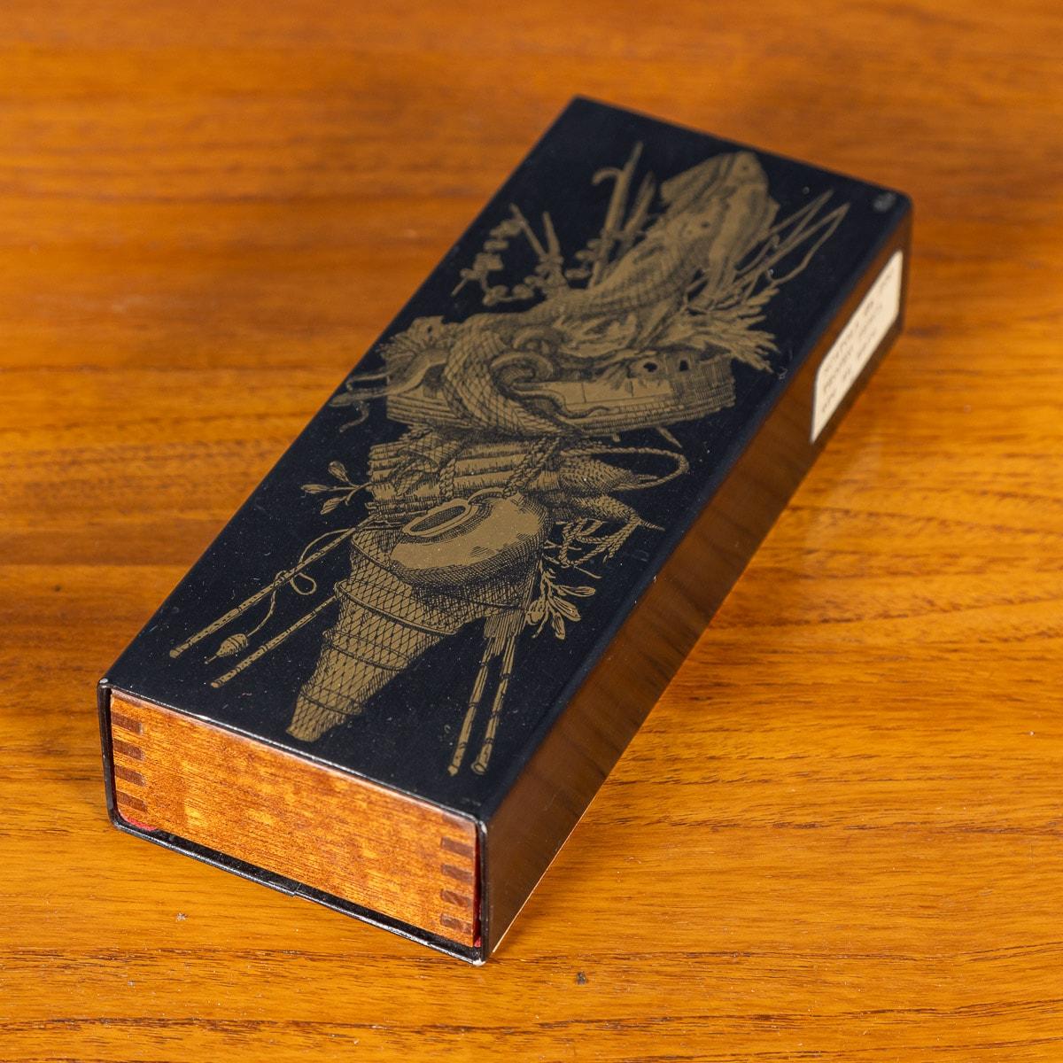 A delightful glove box or trinket box by Piero Fornasetti, circa 1960s / 1970s, with sliding cedar interior, bearing the label 'Trofeo, Pesca' to the side of the box. The exterior is lacquered with depictions of traditional fishing trophies. These