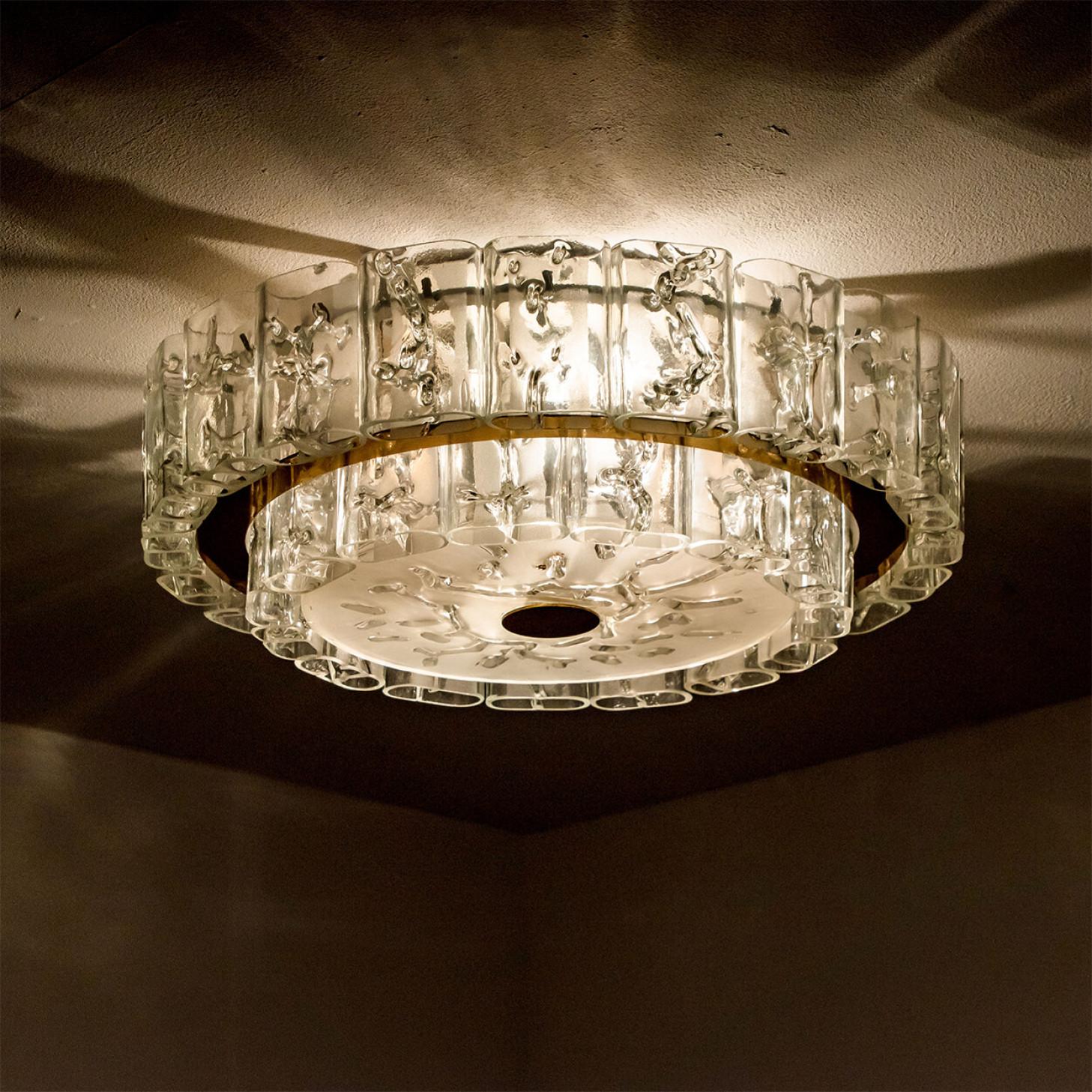 A beautiful Doria flush mount manufactured circa 1960.
High-end thick clear crystal glass shade made out of overlay glass, applied in rectangular shapes. Mind blowing lighting effect when lit!
Doria received the German award for design excellence,