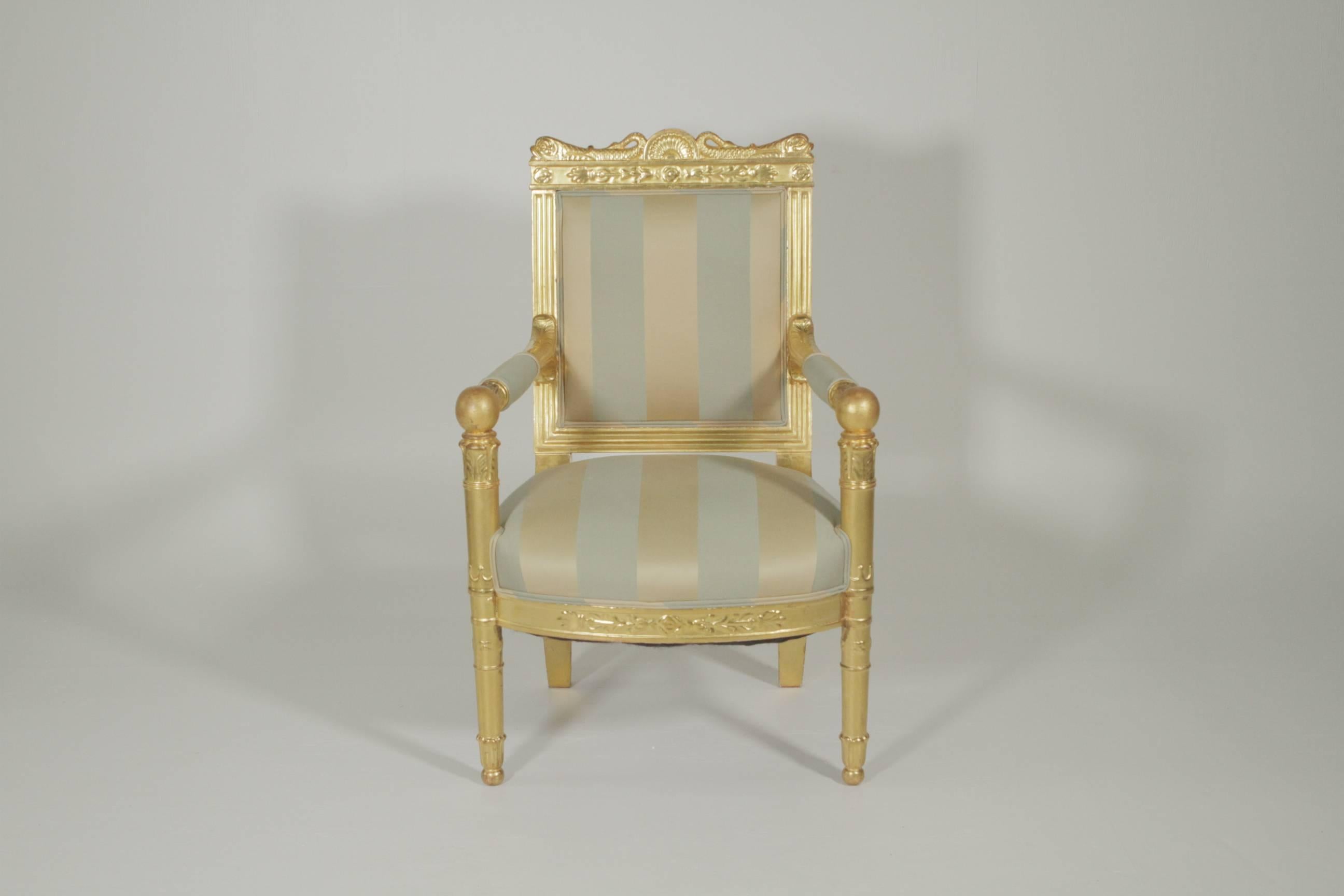 Beautiful gold gilt armchair with silk upholstery, circa 1880-1900. The top rail with dolphin motif corners with open arm sides with cannon ball corners.
                     