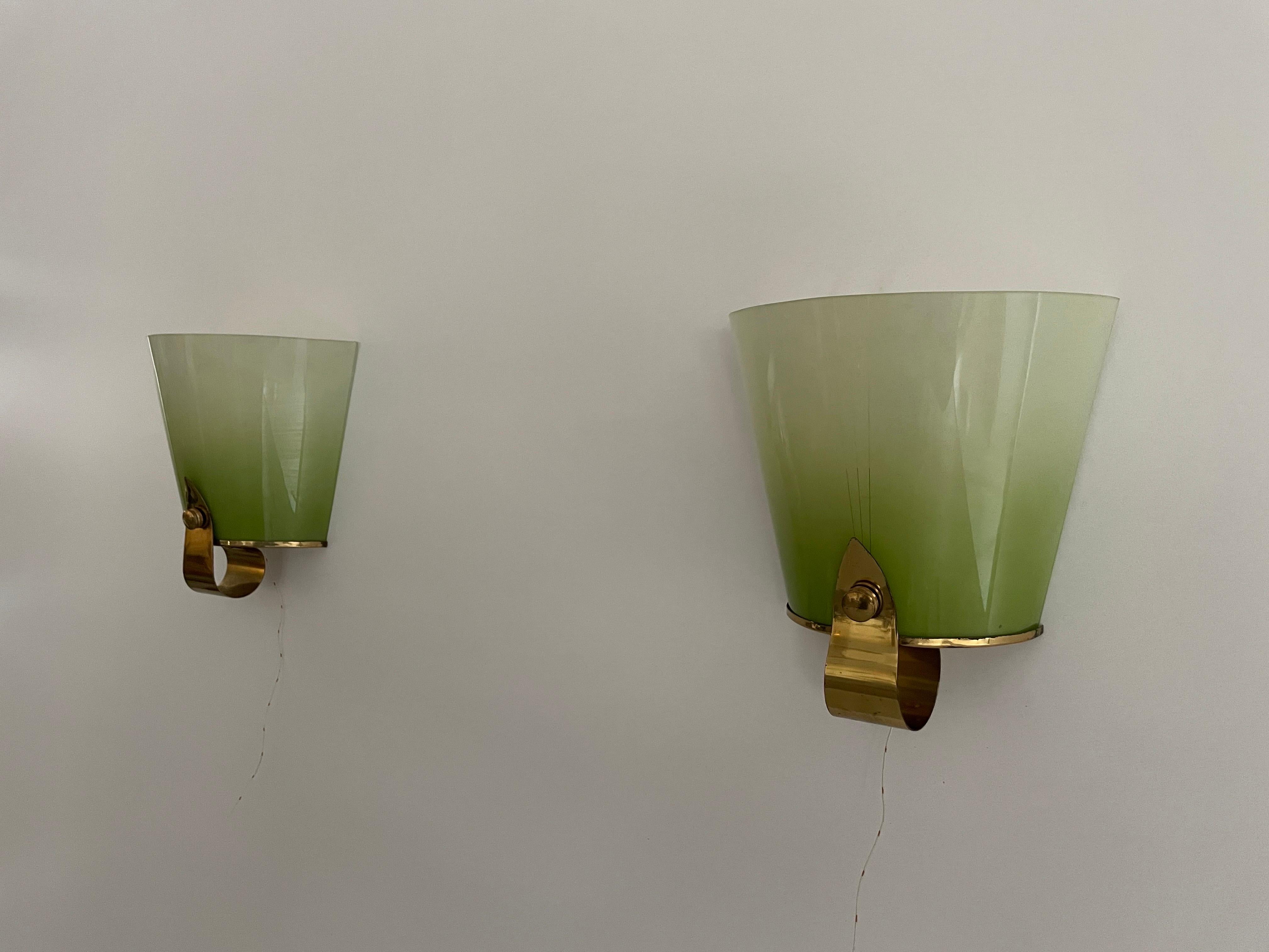 Beautiful Green Glass & Brass Pair of Sconces, 1960s, Germany

Very elegant and minimal design wall lamps
Lamp is in very good condition.

These lamps works with E27 standard light bulbs. 
Wired and suitable to use in all countries. (110-220