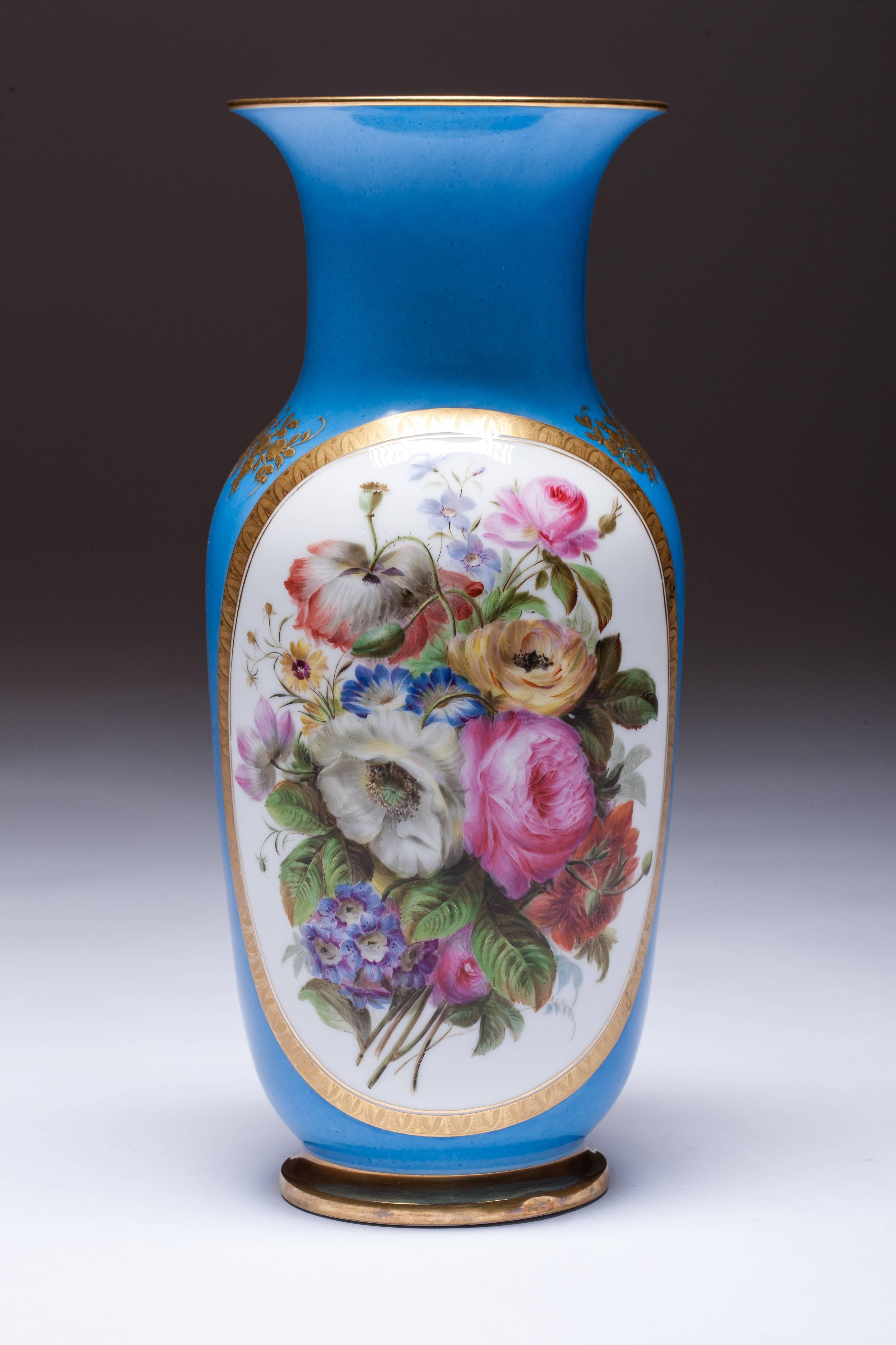 Beautiful big hand-painted Old Paris Porcelain vase. Decorated with lush floral bouquets, enclosed on a blue ground with golden tape. Reverse side of the vase is decorated embossed golden flower surface.

Old Paris porcelain or as the French say