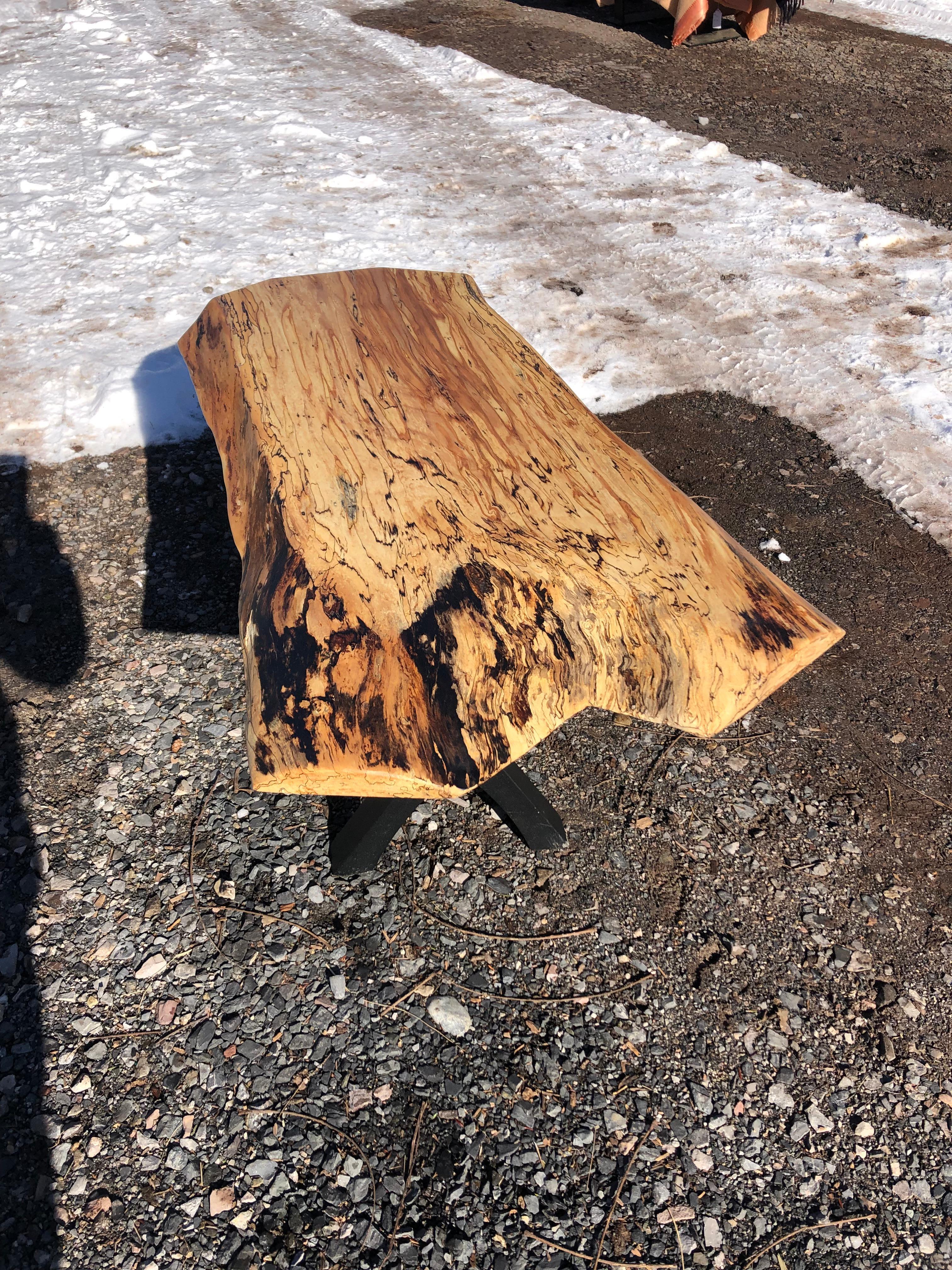 Beautifully handcrafted by an Amish artisan, a one of a kind live edge maple slab coffee table having gorgeous grain and character. The legs are black wrought iron with a X motif.
Depth from front to back varies from 24 to 19.5
Slab is 3
