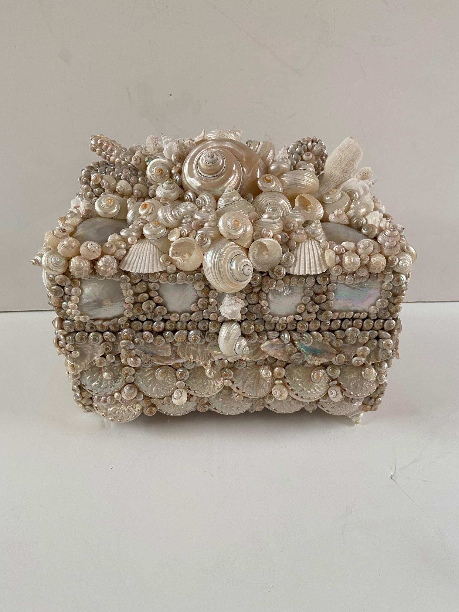 Beautiful handmade shell encrusted box with painted interior, the box could be used for jewelry or
just as ornamentation.