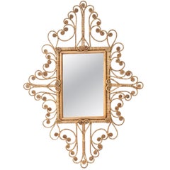Bellissimo specchio in rattan intrecciato a mano con ornamento di volute