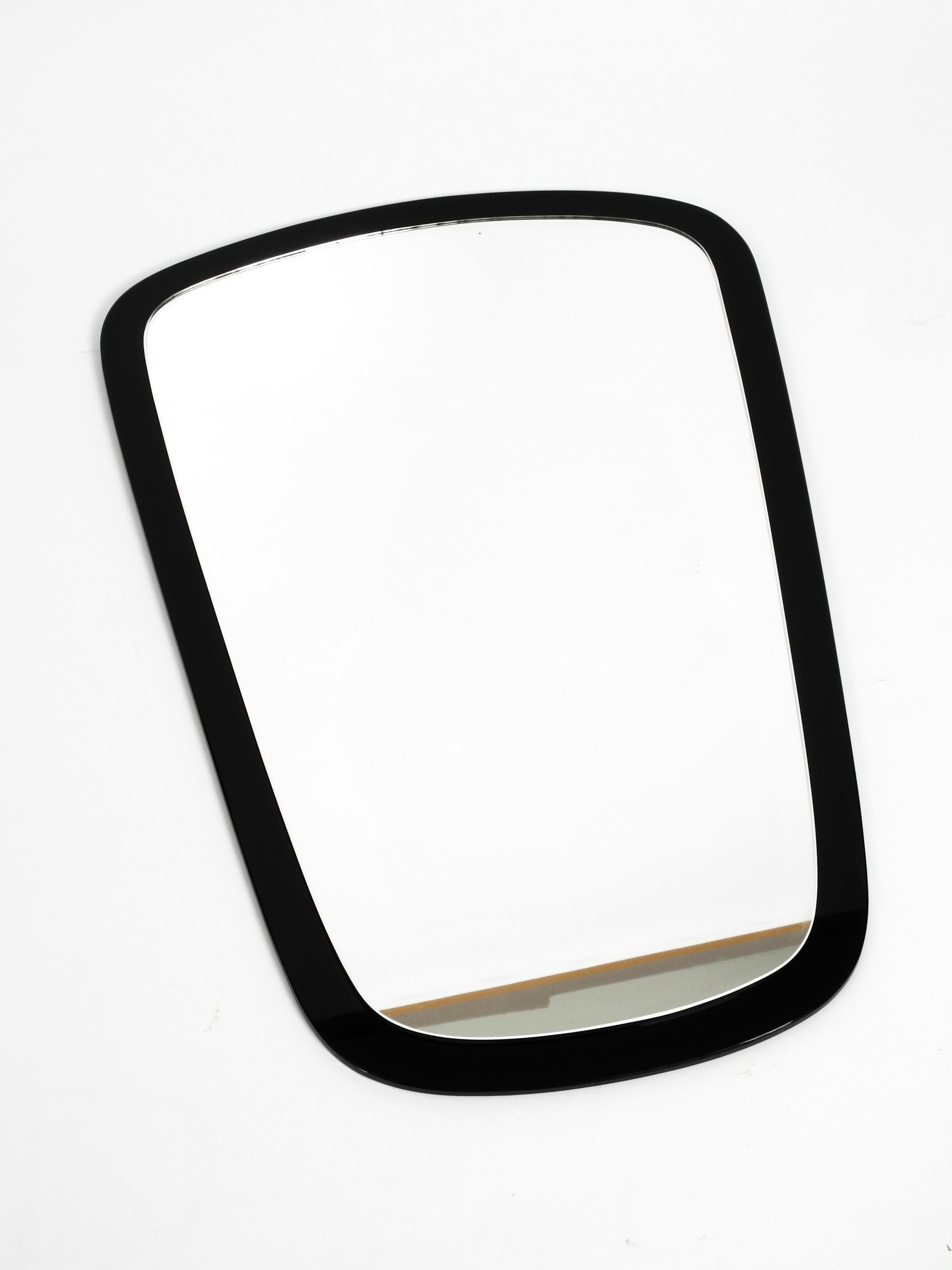 Beautiful high quality Mid-Century Modern double glass wall mirror. 
The mirror glass is glued to a black heavy glass background. 
Great minimalistic exceptional design. Very heavy weight about 6 kg.
Very good vintage condition. No damages to the