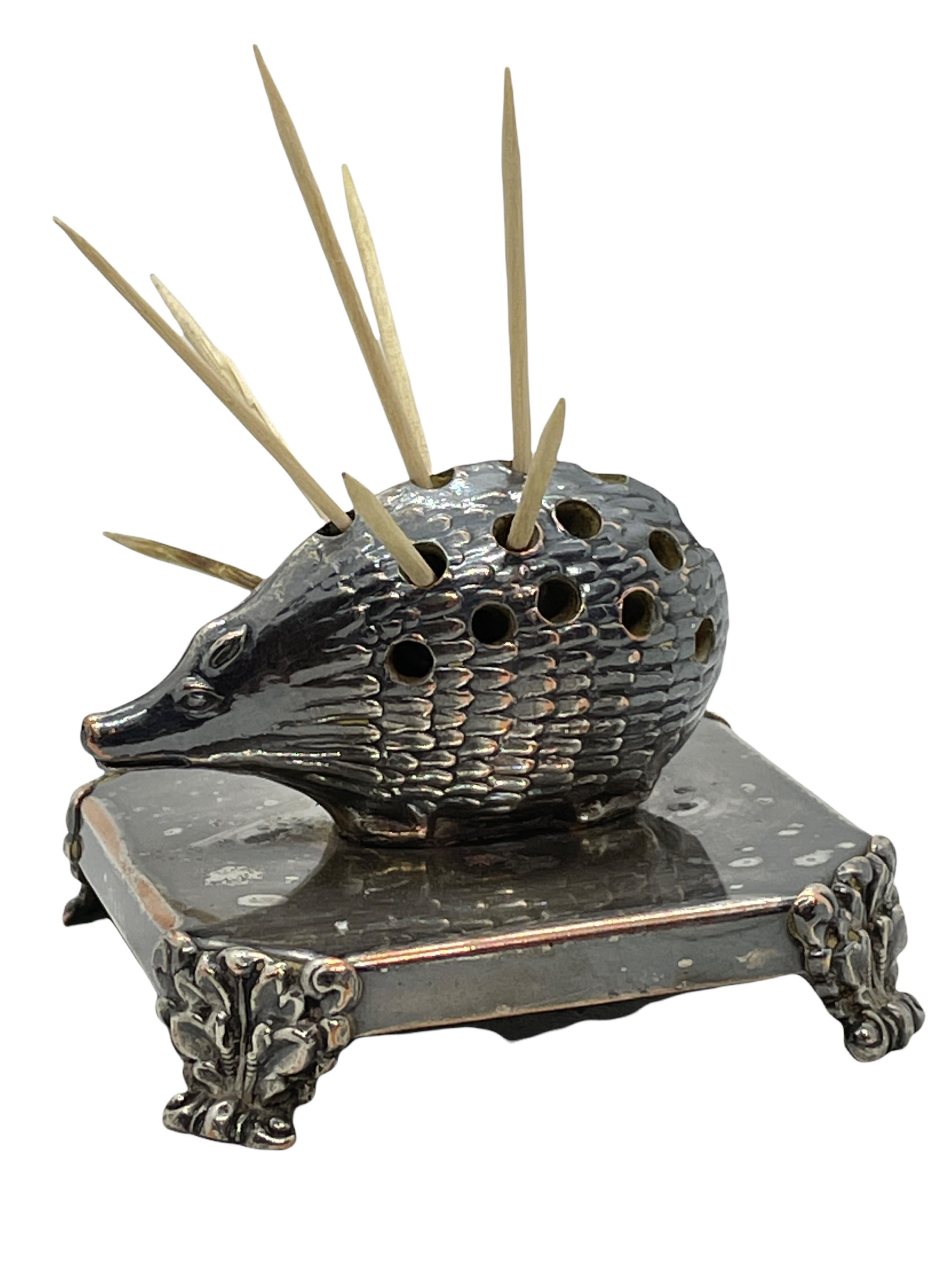 An antique decorative toothpick holder figure. Made of silver plated metal. A nice original antique item for displaying or just to use on your table. Toothpicks shown in pictures are not included in this offer. It is in the original as found