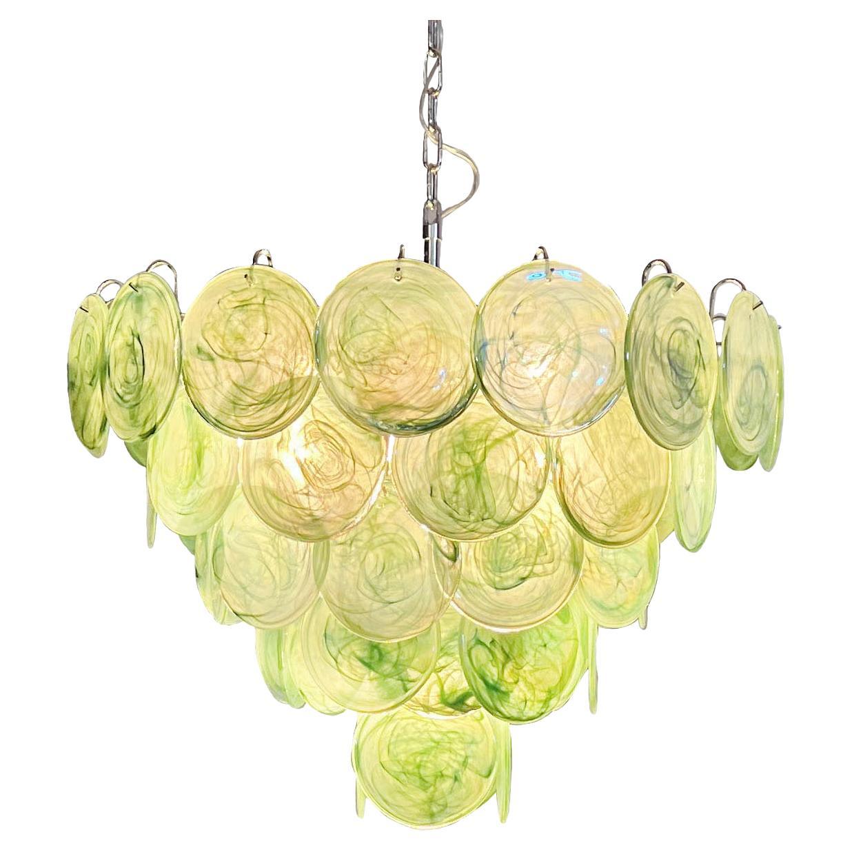 Italian Murano chandelier. The chandelier has 57 Murano GREEN alabaster iridescent glass disks. The glasses are now unavailable, they have the particularity of reflecting a multiplicity of colors, which makes the chandelier a true work of art.