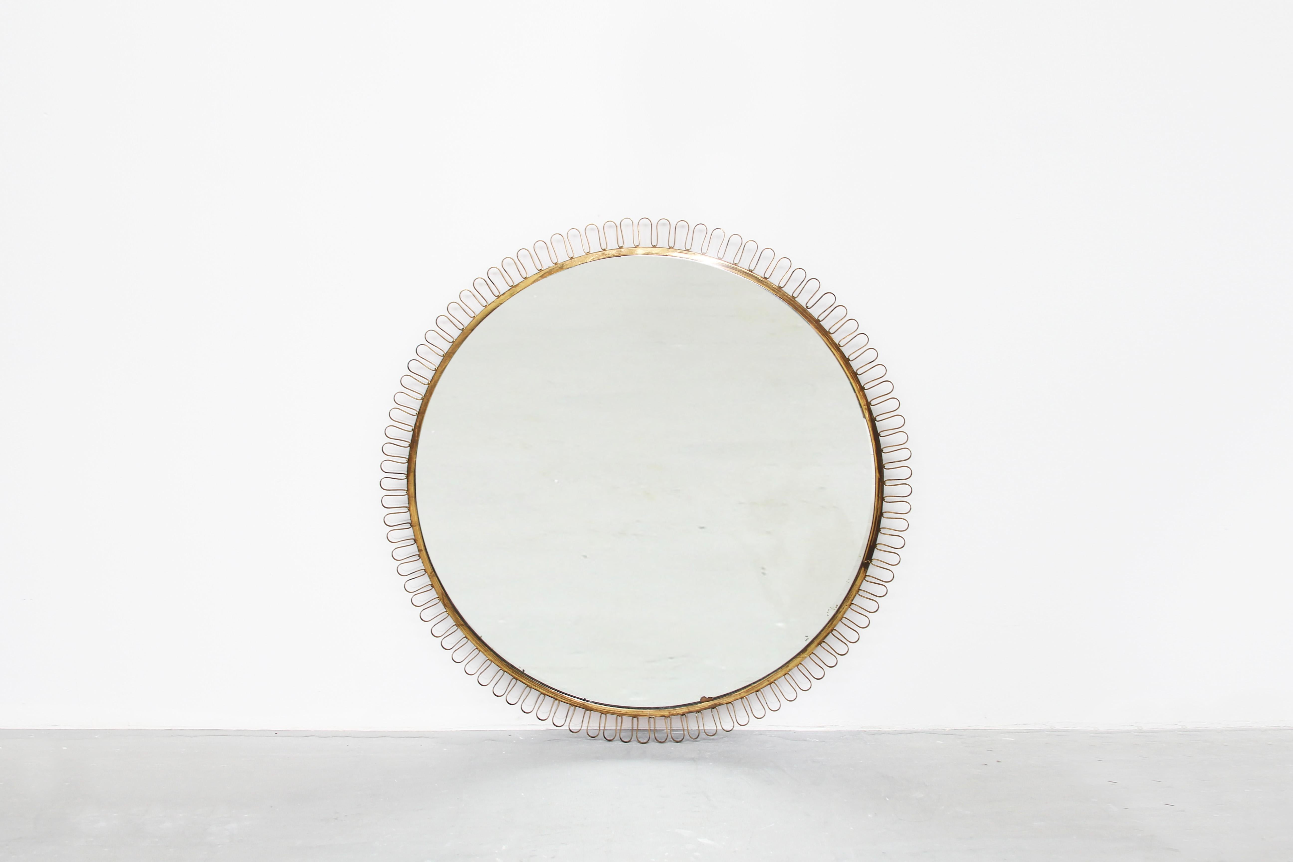 Amazing huge round wall mirror attributed to Josef Frank for Svenskt Tenn, Sweden, 1940s.
The mirror itself shows some patina: There are some little stains and light discoloration on some parts, but it is looking very beautiful! Dimensions: 100cm
