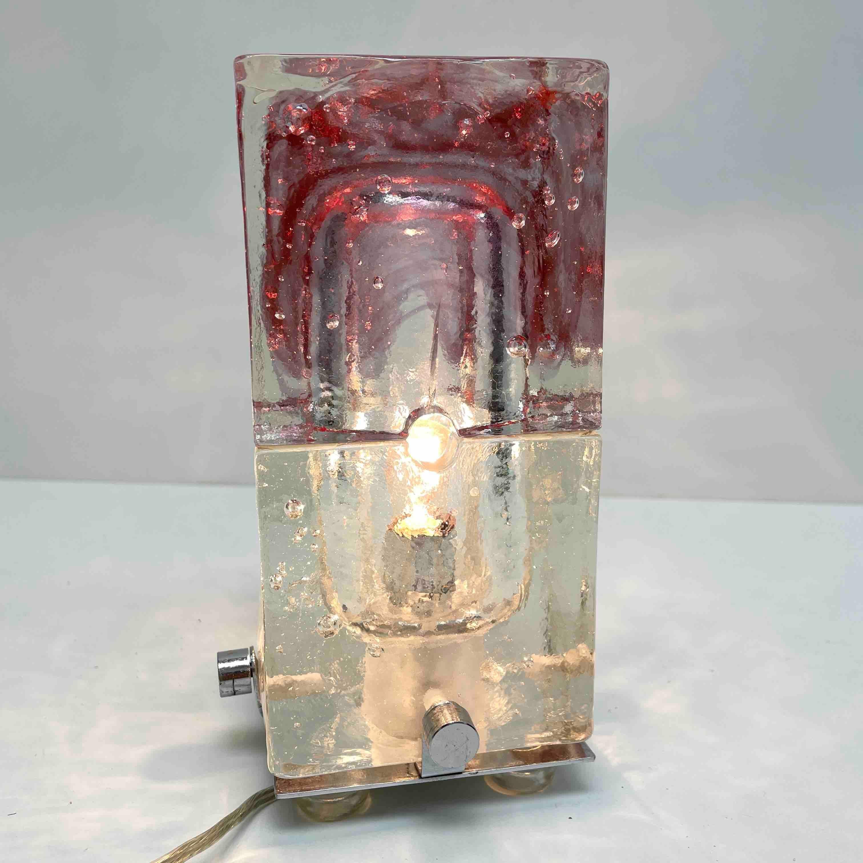 Beautiful ice block table lamp. Made of heavy glass and a chrome base, made in Murano Italy. The Fixture requires one European E14 / 110 Volt small bulb, up to 40 watts. A beautiful addition to any room.