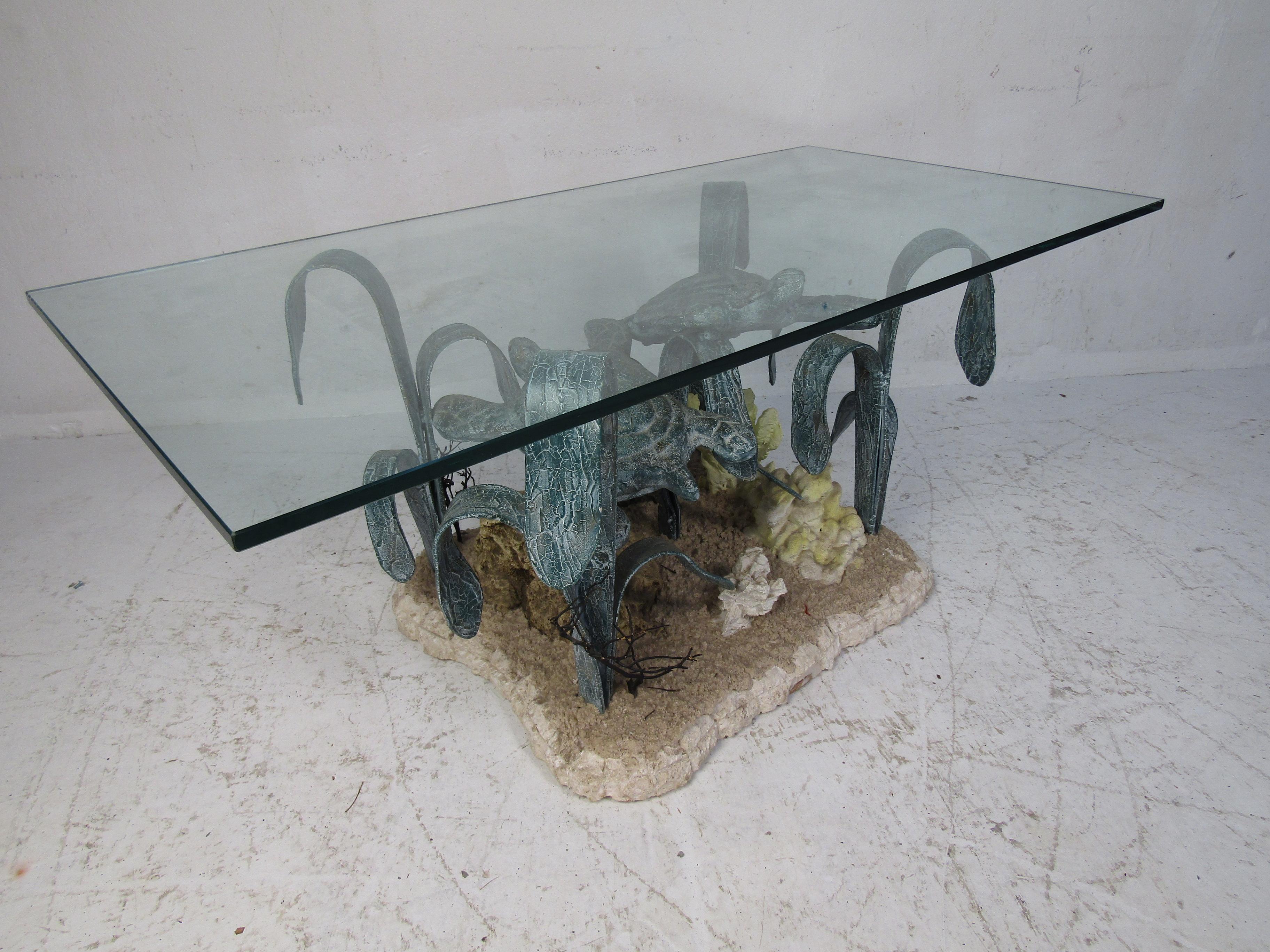 Elegant modern marine life coffee table with a glass top. Wonderful patinated base with sculptures of turtles and seaweed swimming above the coral. The 1/2 thick rectangular glass top offers plenty of room for guests while they gaze upon the