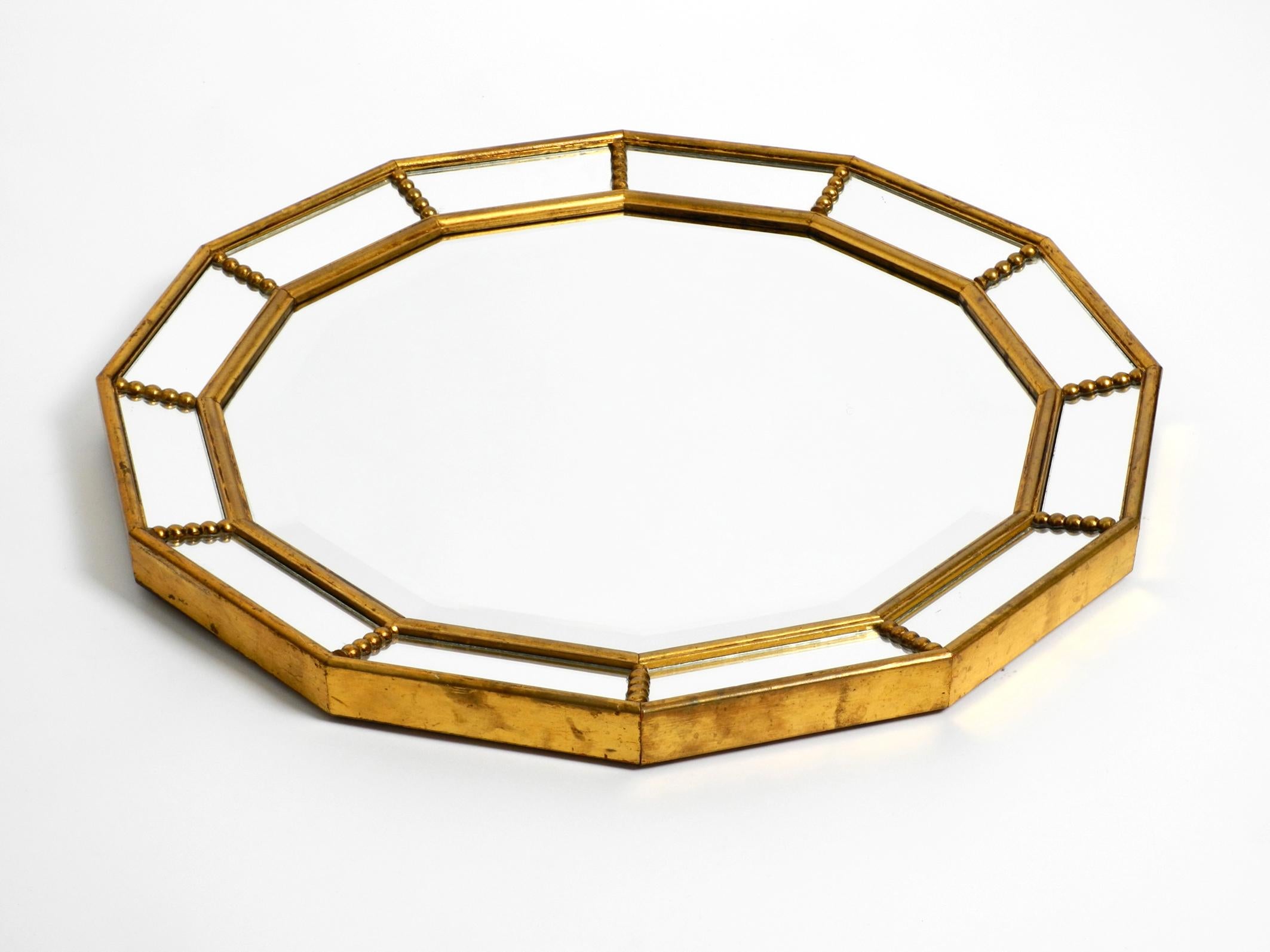 Beautiful Italian dodecagon wooden wall mirror, gold-plated.
Great Italian elegant design from the 1960s.
The frame is made of solid wood, on which the facetted mirror is in the middle 
and outside 12 small mirrors are arranged at an angle.
Very