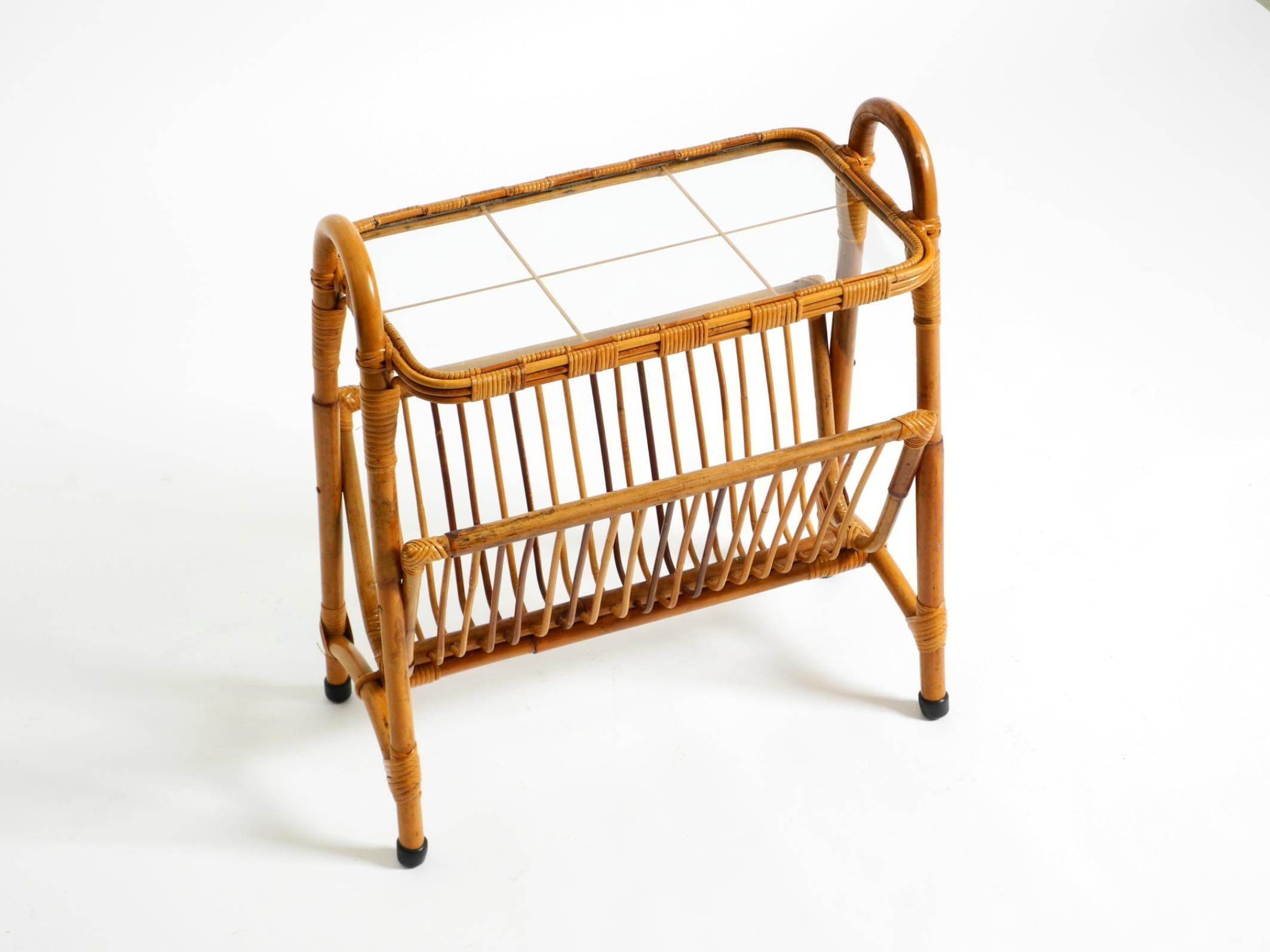 Beautiful original Italian 1960s bamboo side table and magazine rack.
Shelf with the original glass top.
Very high-quality, great design. In very good vintage condition with a beautiful patina.
No damage to the rattan frame, not wobbly, everything
