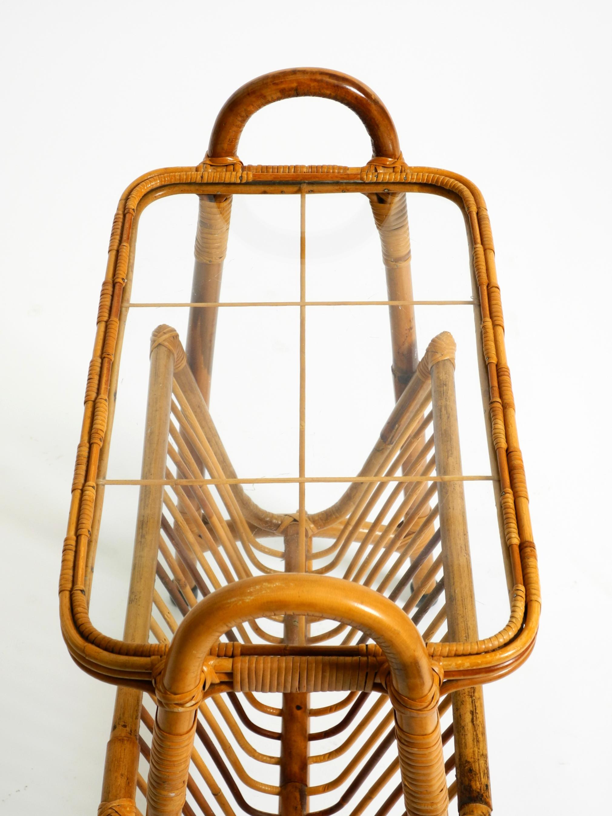Metà XX secolo Beautiful Italian 1660s small bamboo side table with glass top and magazine rack in vendita