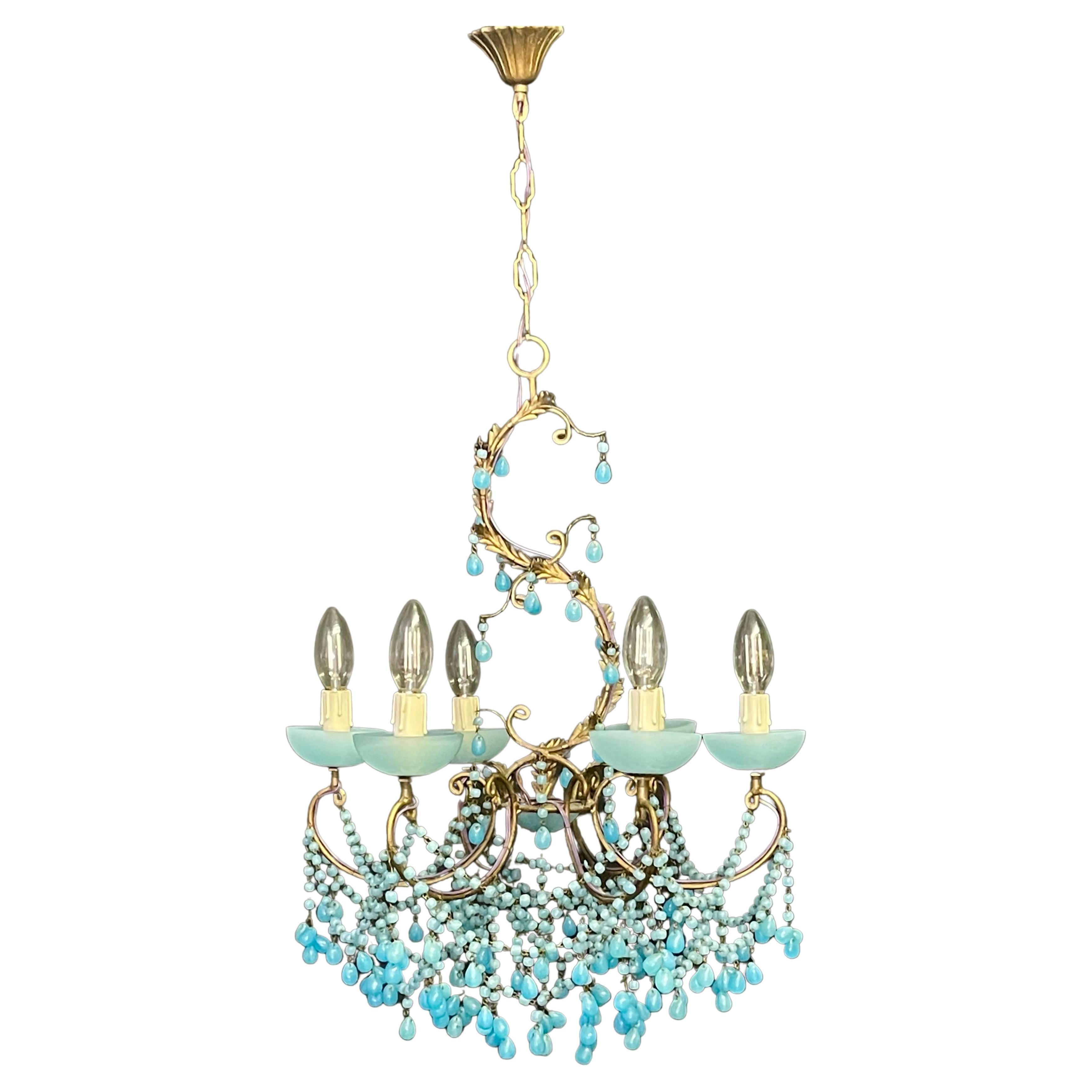 A wonderful aqua opaline blue chandelier, Italy, circa 1930s.
This beautiful handcrafted chandelier is made of patinated metal/iron decorated with aqua opaline blue Murano glass drops.
Socket: e 14 for standard screw bulbs.




