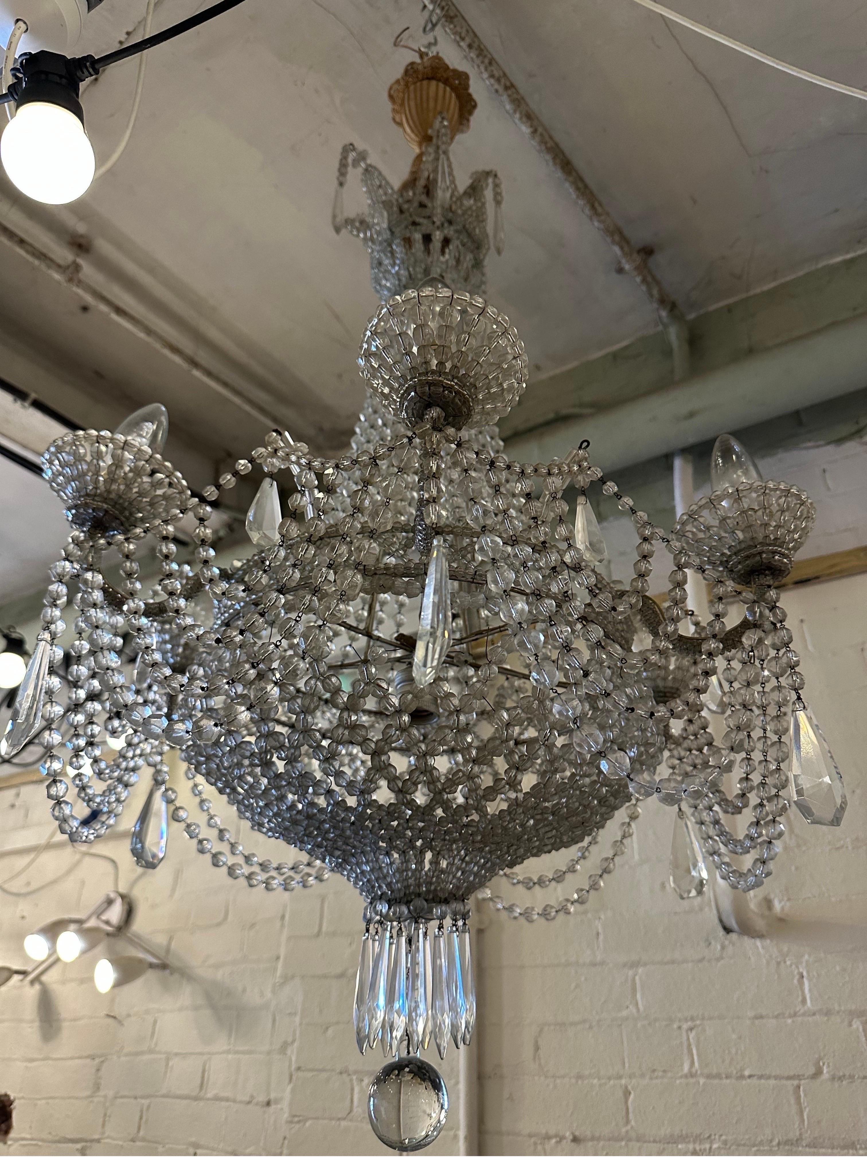 Introducing the epitome of luxury and sophistication - the Italian Crystal Empire Chandelier. 

Indulge in the timeless beauty and mesmerizing brilliance of this exquisite masterpiece, meticulously handcrafted in Italy. This chandelier effortlessly