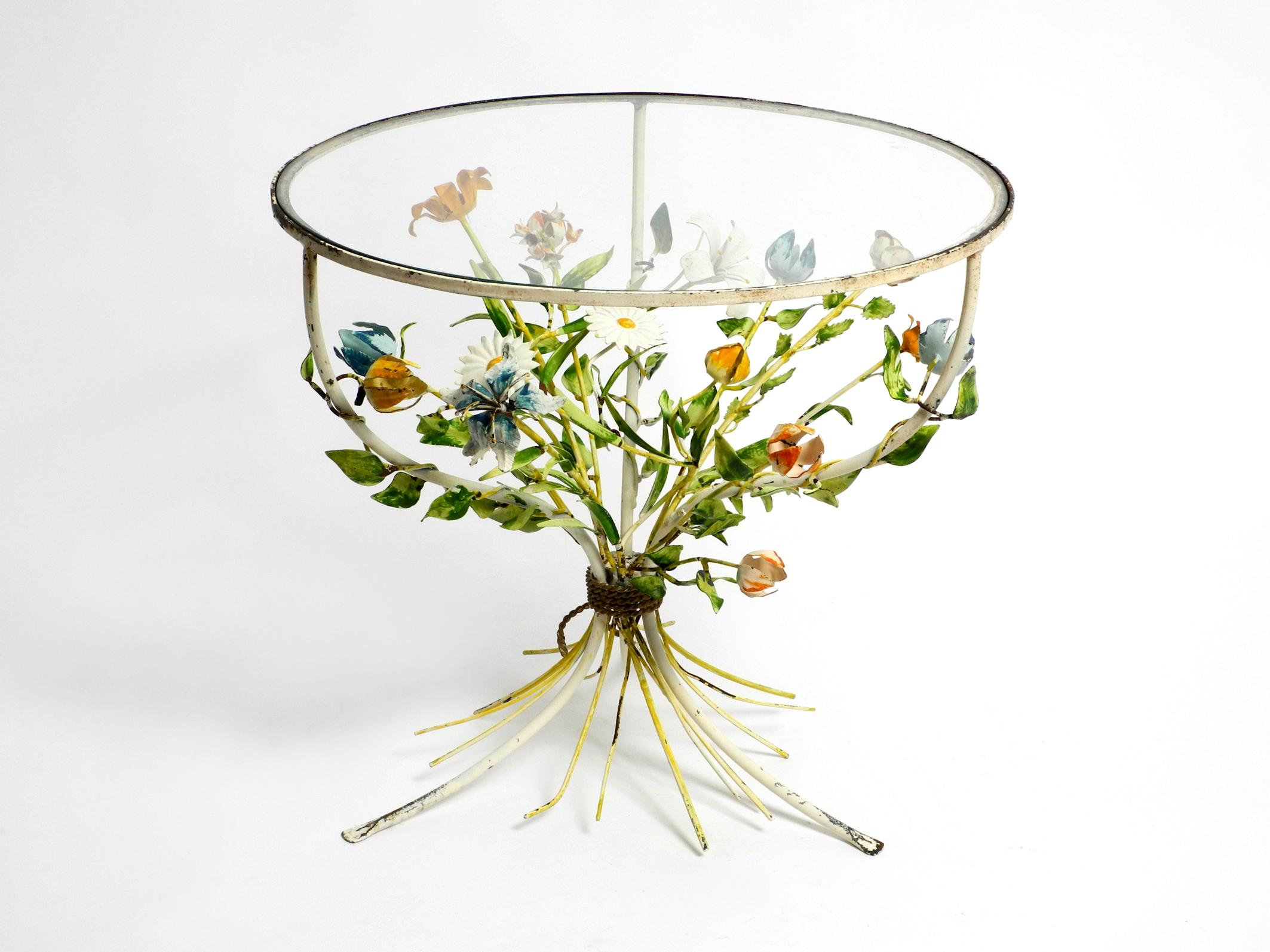 Very rare Italian original mid century glass metal side table.
Beautiful floral 1950s design in a good vintage condition.
Round tripod frame made entirely of metal in the middle with lots of leaves and flowers.
Very high quality made, leaves and