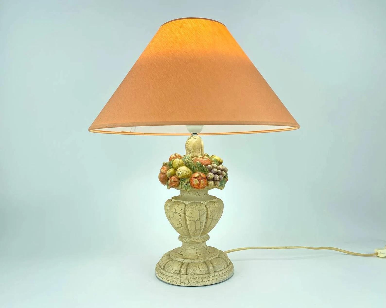 Beautiful Italian table lamp. Prism Arte Manufactory. 1980s'.

Italian style resin table lamp with colorful fruits on the Ivory colored pedestal. Large fabric orange lampshade gives the lamp even more charm!

Whether placed in the bedroom or the