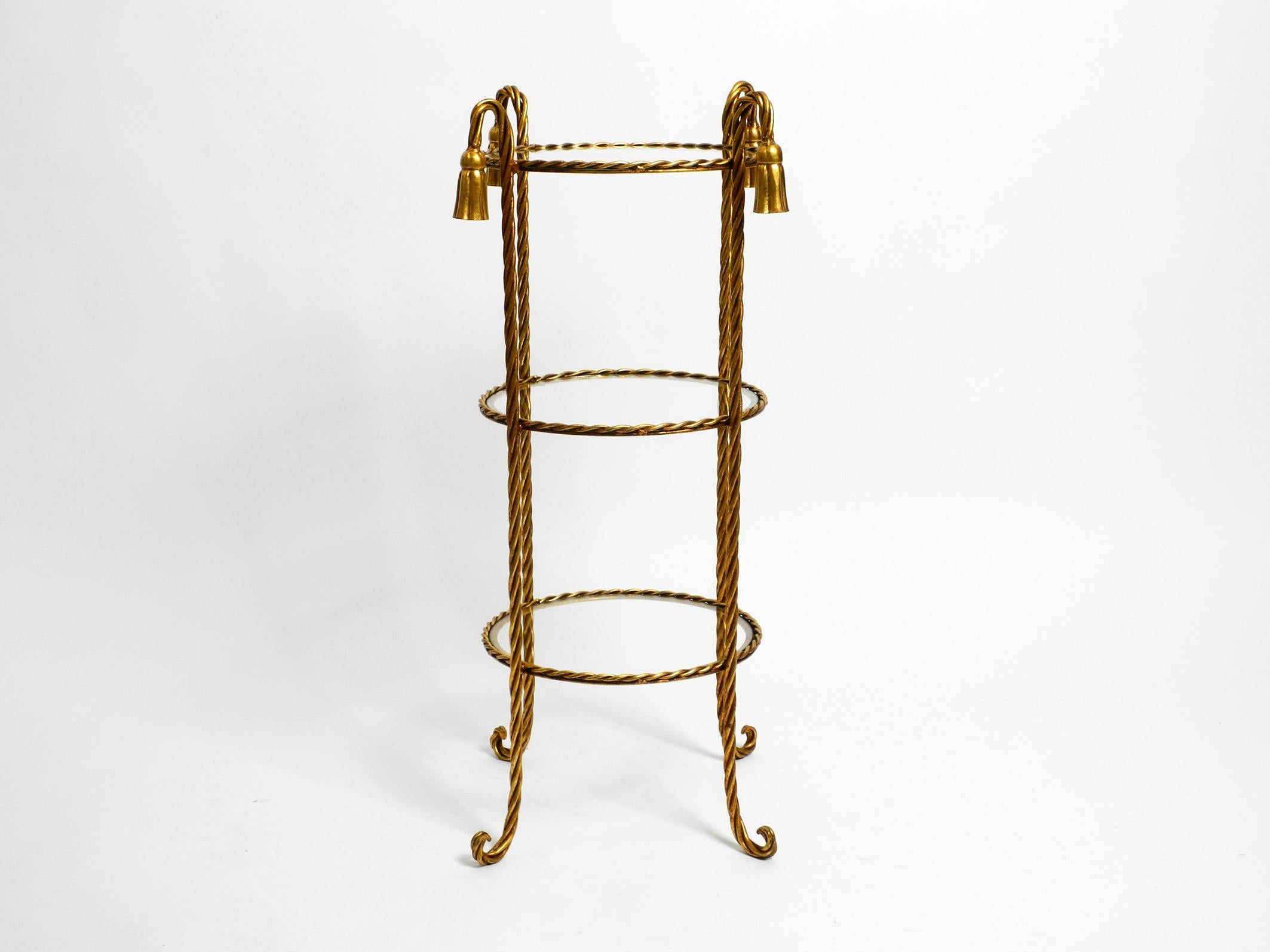 Very elegant Mid Century Regency side table made of gilded iron.
The manufacturer is Li Puma Firenze. Made in Italy. Very rare in height and width.
Made from twisted gilded iron. Very high quality, elegant workmanship.
Beautiful 1960s design with