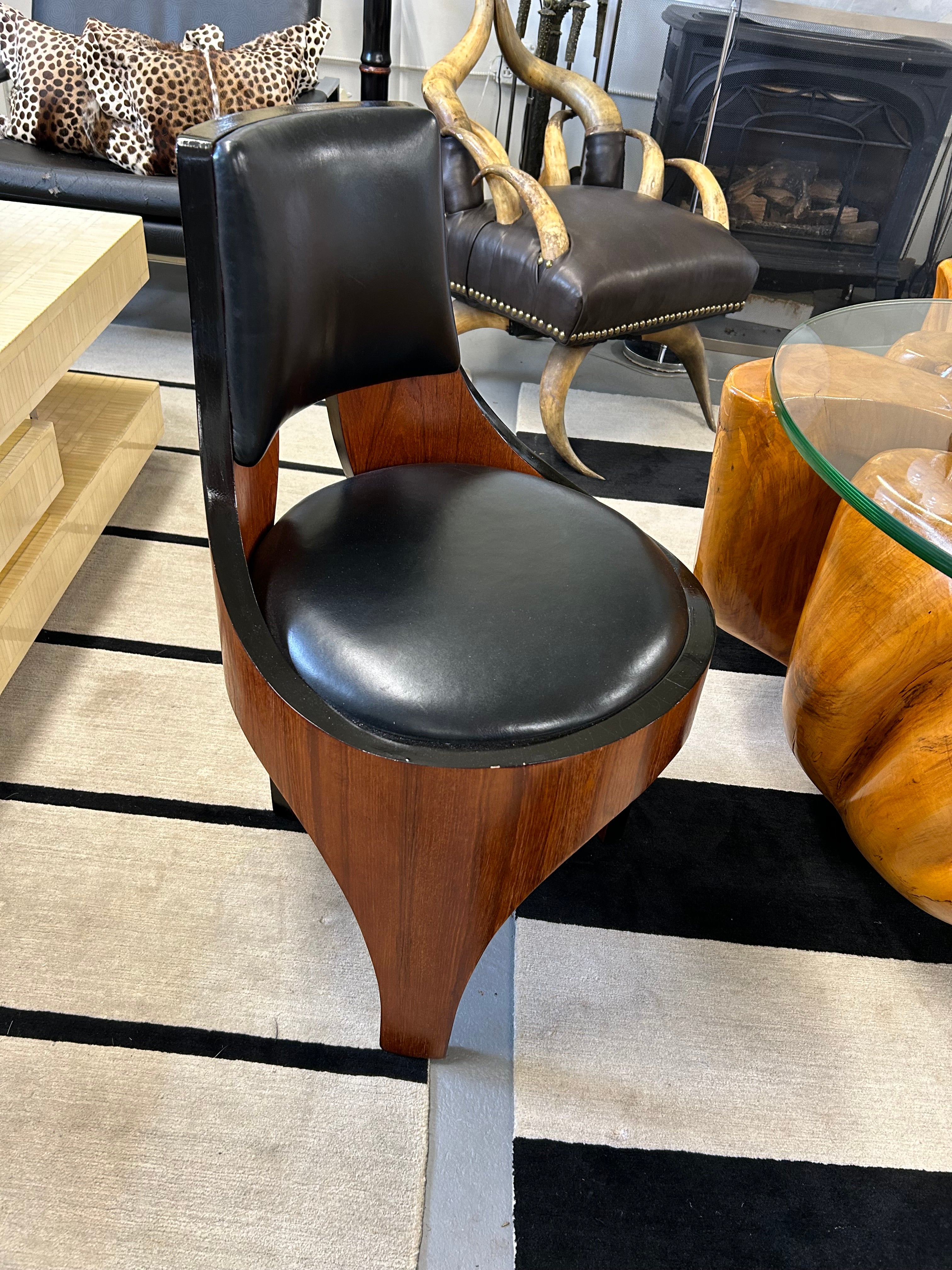 Beautifully shaped Italian barrel chair having richly grained mahogany form and contrasting black leather upholstery.  Striking silhouette from the back.

Preston
