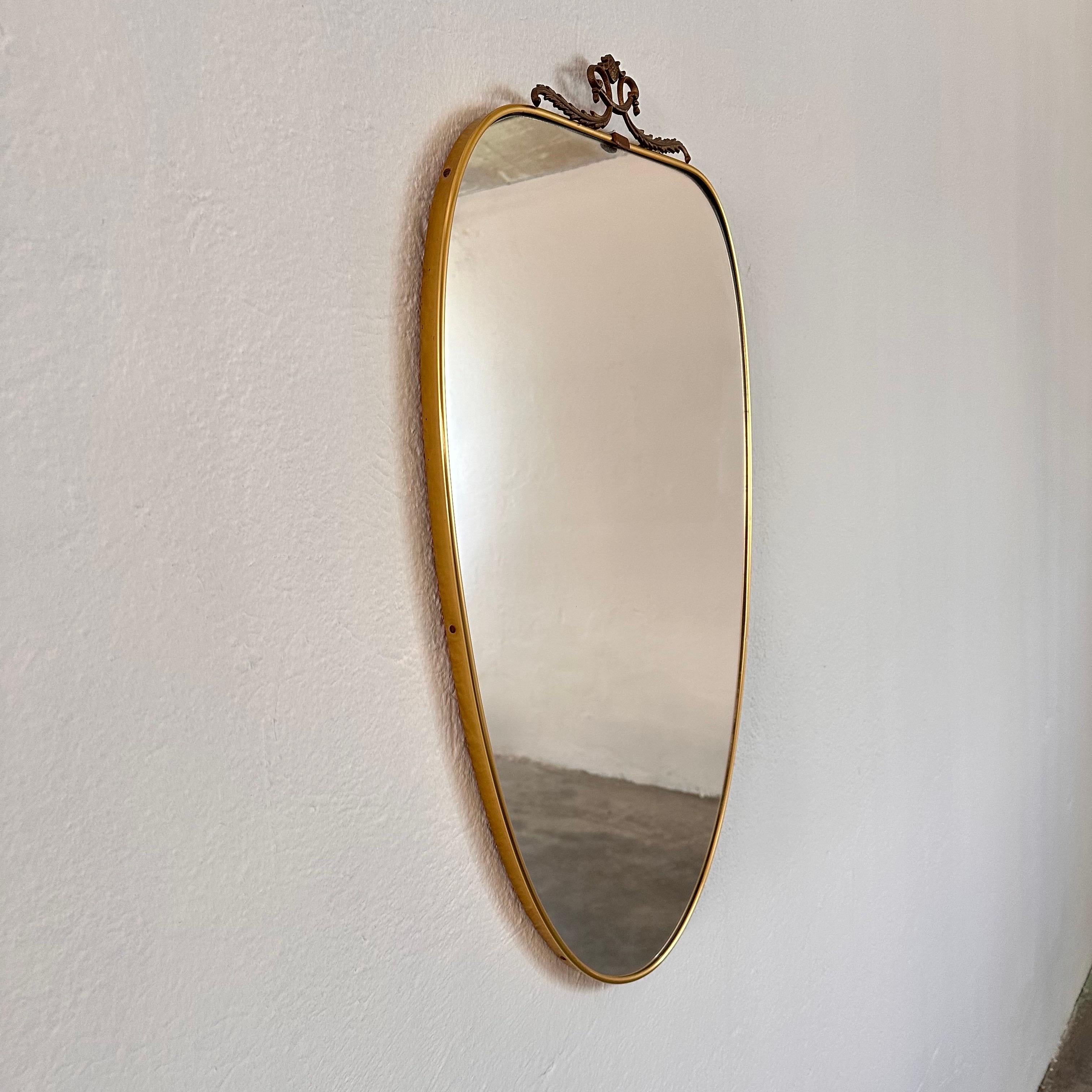 
Elevate your interior with this stunning shield mirror, crafted in Italy during the 1950s and designed in the iconic style reminiscent of Gio Ponti. With its sleek lines and timeless elegance, this mirror is sure to make a statement in any